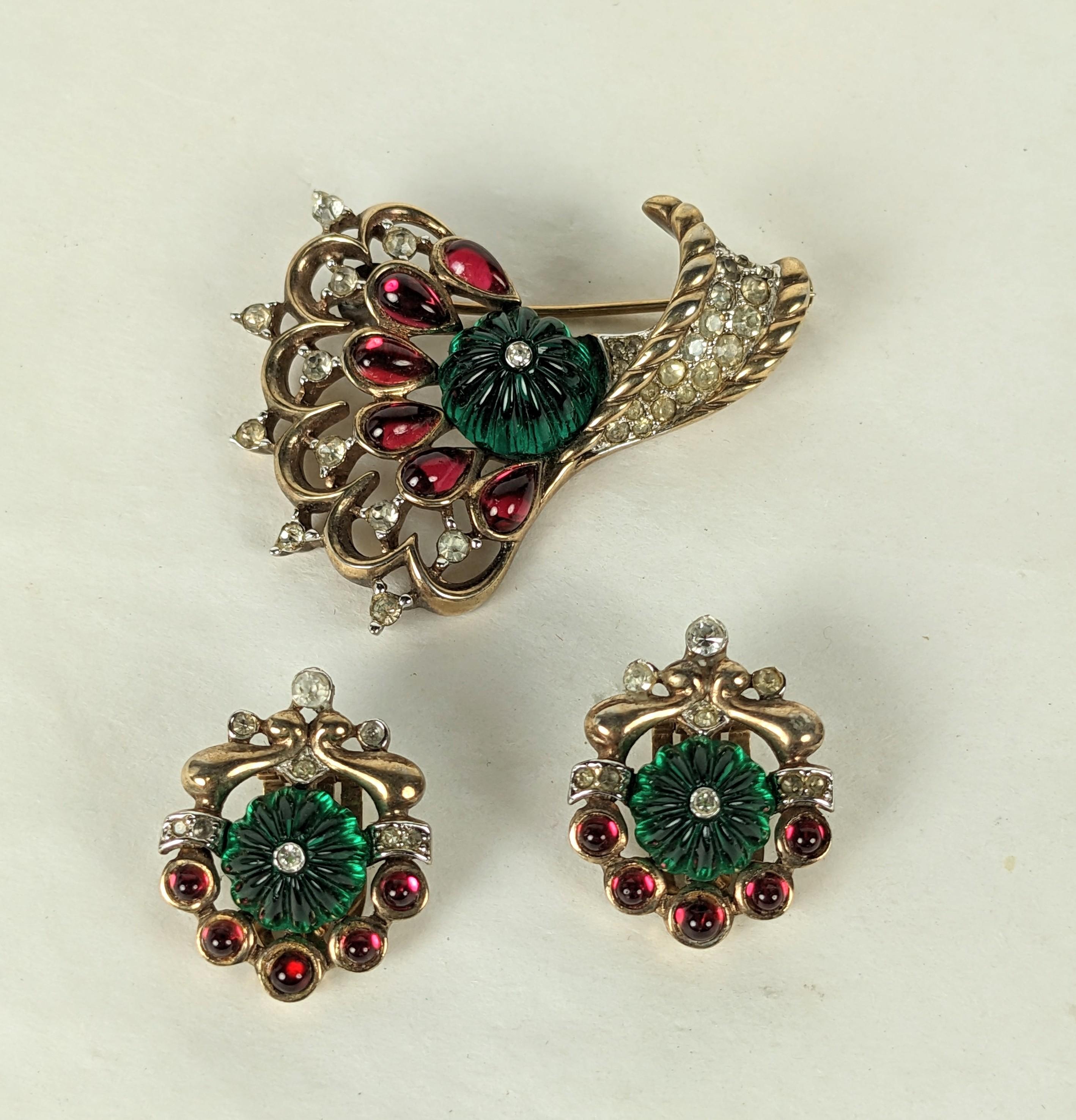 Trifari Jewels of India Moghul Set circa 1949 by Alfred Phillipe. Scroll brooch with pave accents with matching clip earrings. Fluted faux emeralds with ruby pears shaped stones in rose gold plate.
Brooch 1.75