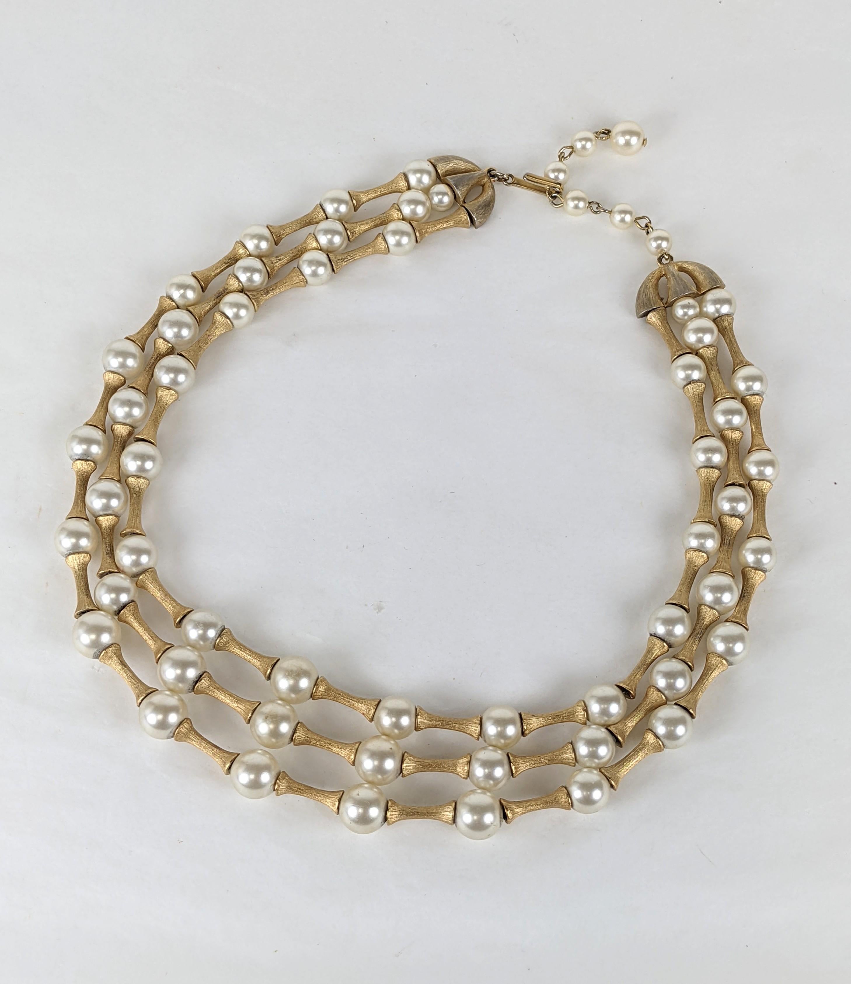 Attractive Trifari Modernist Pearl and Toggle Necklace from the 1960's. 3 graduated strands of faux pearls with florentine spacers in between.  1960's USA. 
Adjustable 14.5