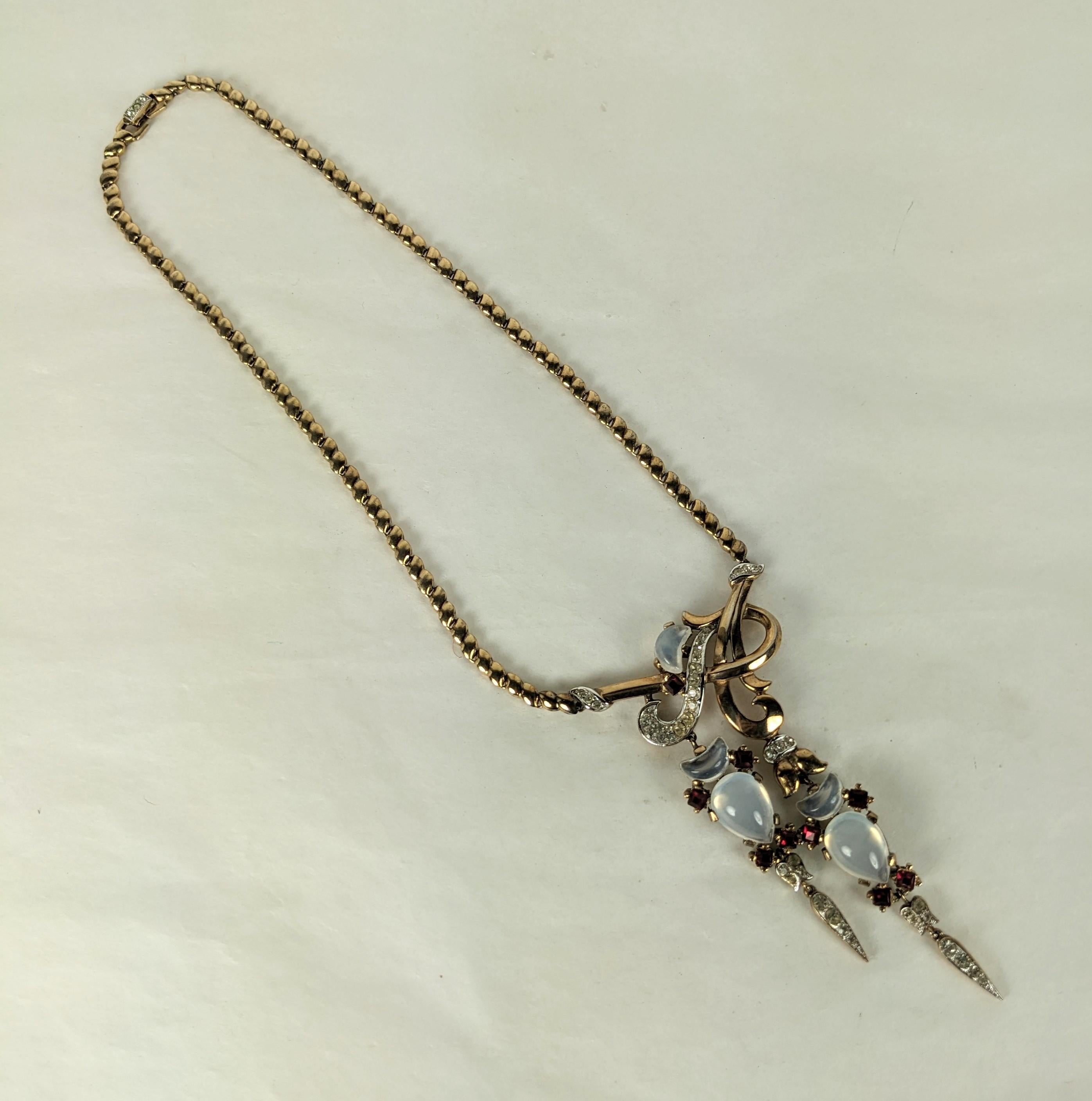 Rare Trifari Alfred Philippe, Clair de Lune collectible and elegant double drop retro necklace of pink gold plate metal, crystal rhinestones and faux demilune cut moonstones and rubies. Excellent Condition. Marked: Trifari with Crown, 1950's USA.