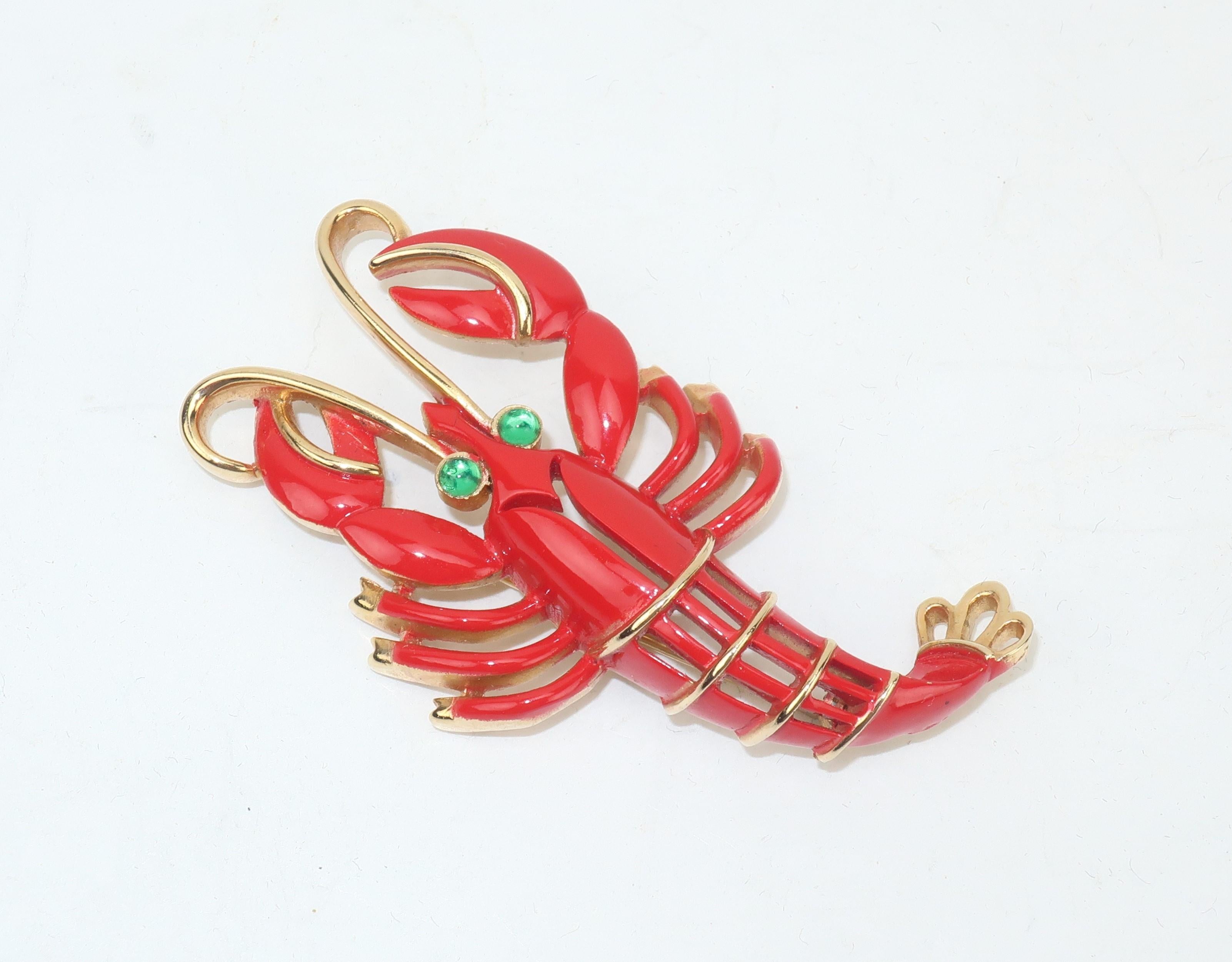 From Trifari's 1960's 'Under the Sea' collection, an adorable lobster brooch in a gold tone metal with bright red enamel and green cabochon eyes.  There is something adorably animated about this little guy including the curl of his antenna and the