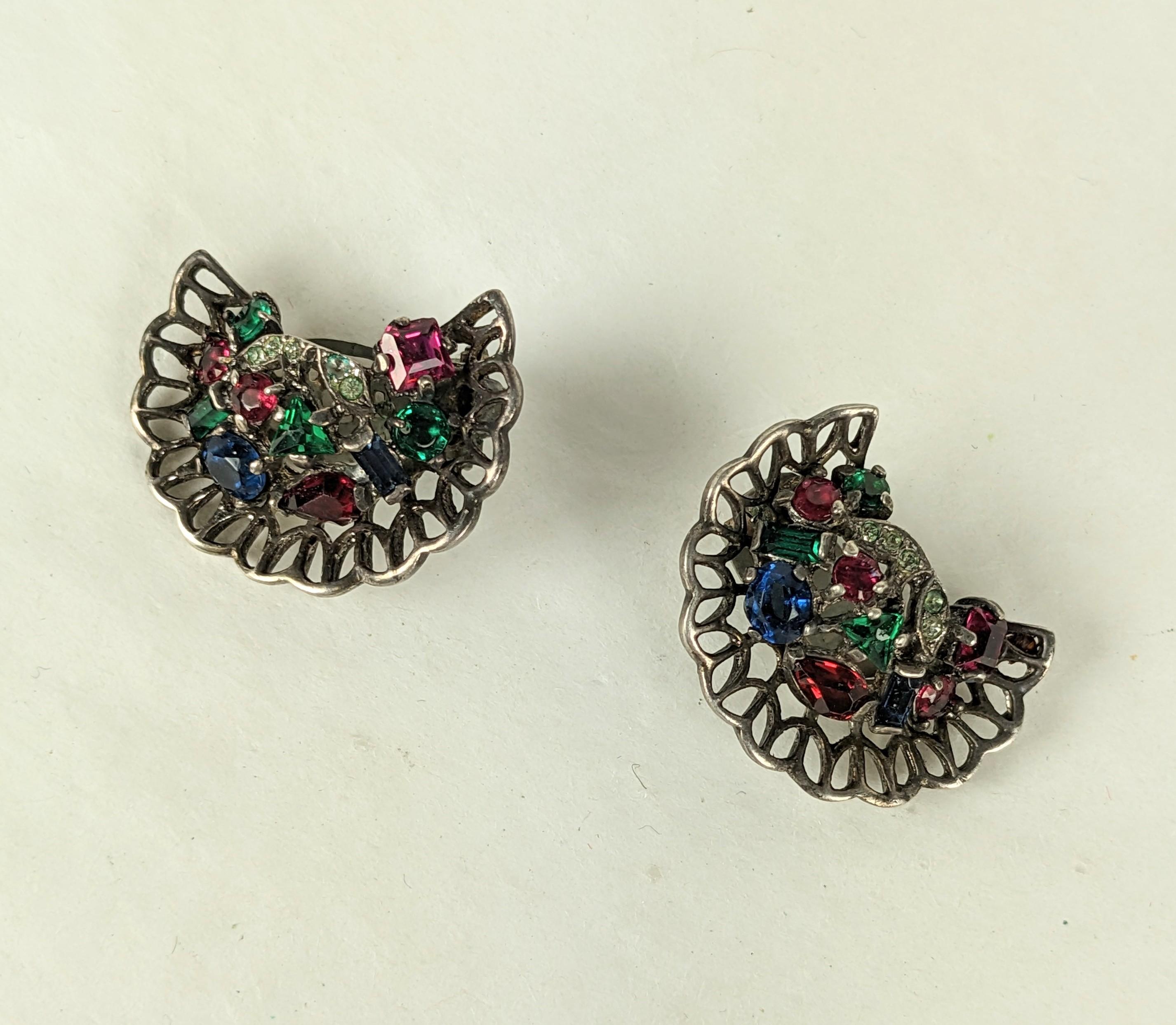 Trifari by Alfred Philippe Riviera Series gilded sterling silver open work earrings from the 1940's. Faux vari cut ruby, emerald, and sapphire gems are set in vermeil sterling silver.
Excellent condition. Clip back fittings.