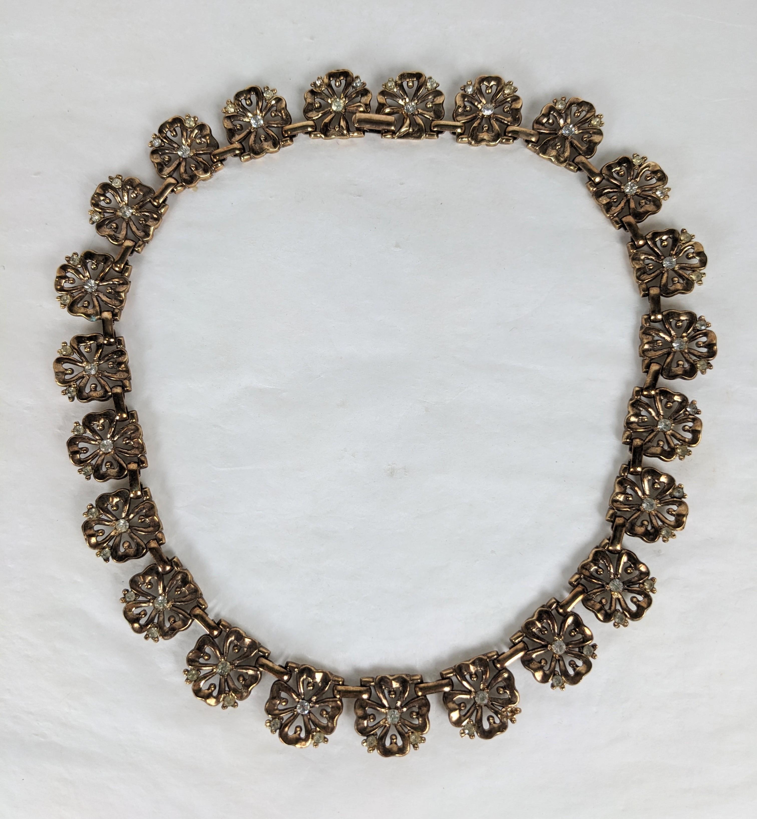Elegant Trifari Rose Gold Plate Pansy Link Necklace from the 1940's with pave accents. Each link is a pierced floral with crystals. 16