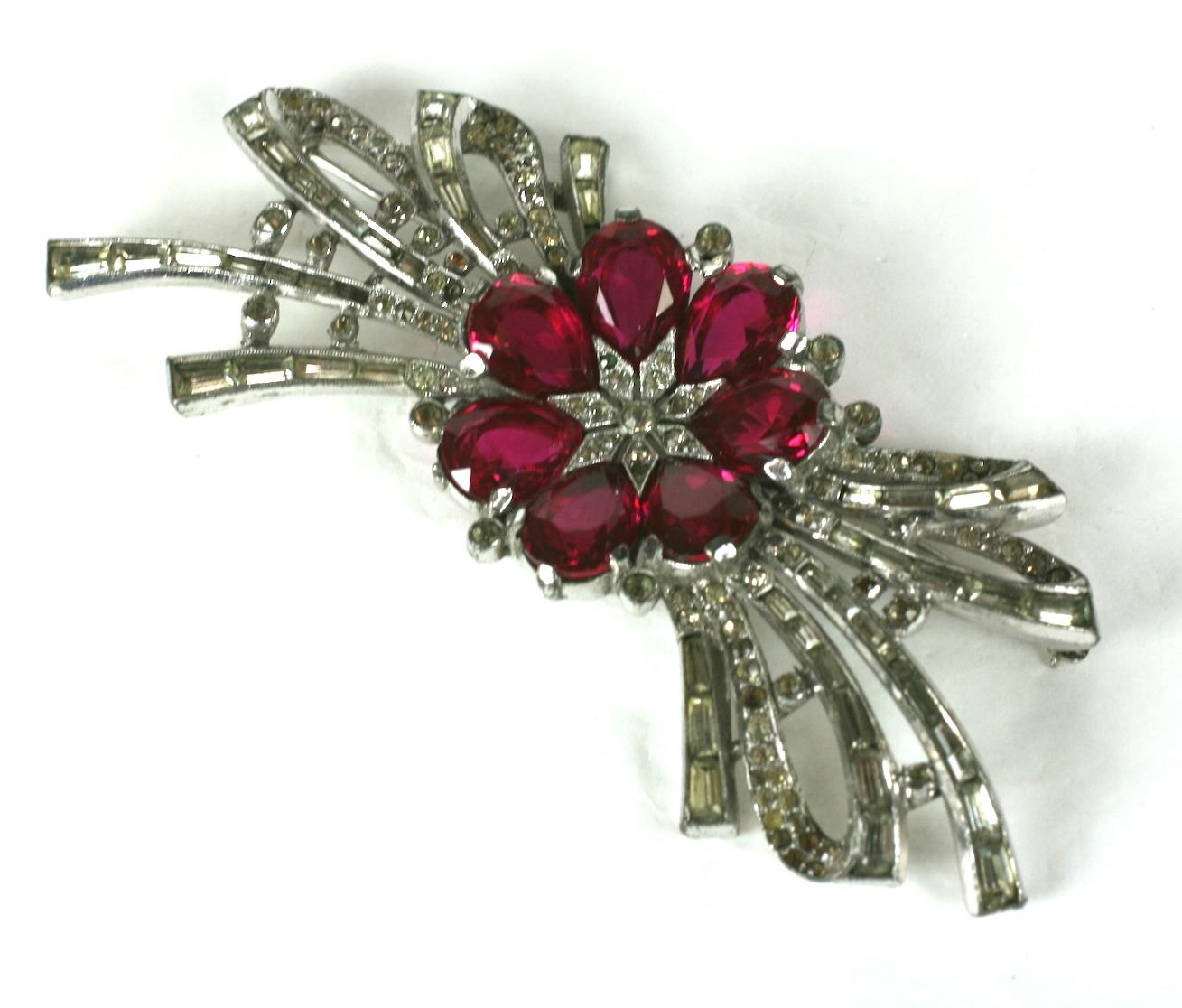 Lovely Trifari Ruby Baguette Spray from the 1930's by Alfred Phillipe. Ruby pear shaped pastes form a central flower motif with loops of hand set baguettes and pave. 
3.75