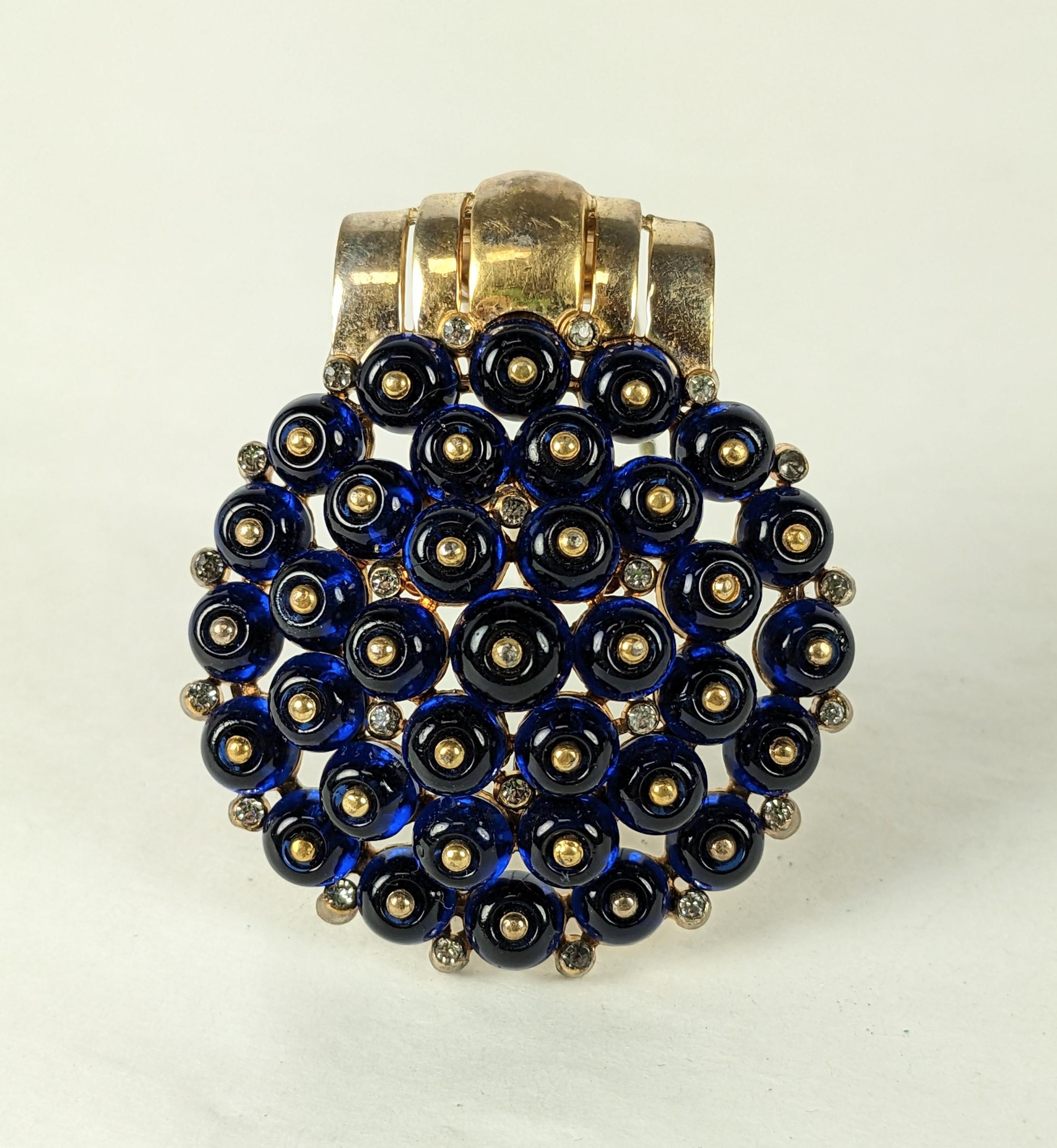 Trifari Sapphire Cab Deco Clip, Alfred Phillipe from the 1930's. A layered dome clip is set with blue cabs and tiny pave accents. 
1930's USA.  2