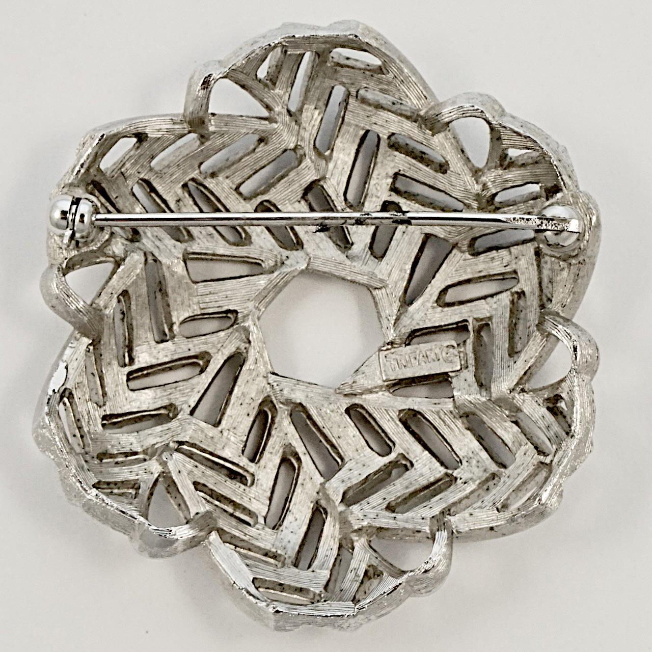 Trifari silver plated brushed and shiny brooch, featuring a beautiful woven design. Measuring diameter 4.6 cm / 1.8 inches. The brooch is in very good condition.

This stylish Trifari brooch is circa 1960s.

Trifari was a talented jeweller who was