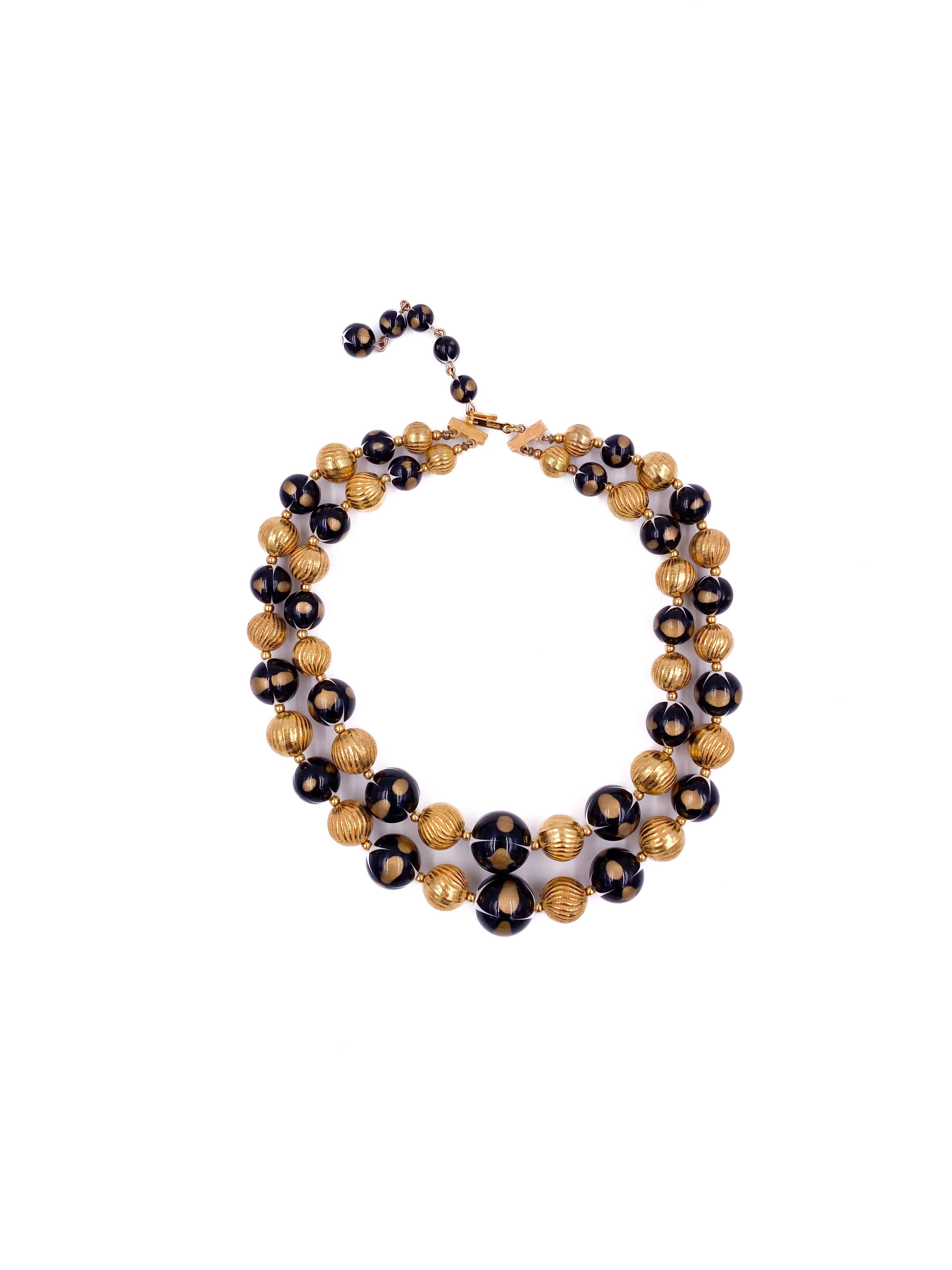Elevate your accessory collection with this Vintage Black/Gold Ball Double Layered Necklace. Featuring two delicate layers, it combines striking gold and black spheres for a sophisticated contrast. Designed to stand out as a statement piece or