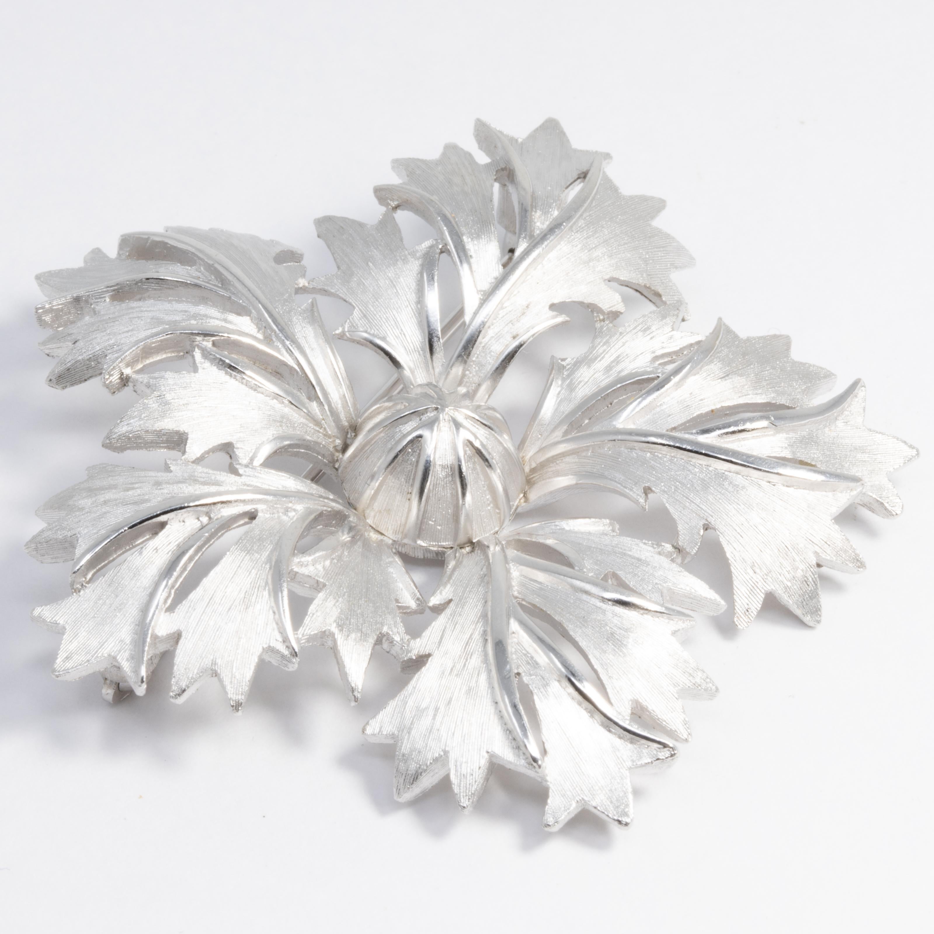 A glamorous flower pin brooch by Trifari in silver!

Silver-tone.

Marks / hallmarks / etc: Trifari