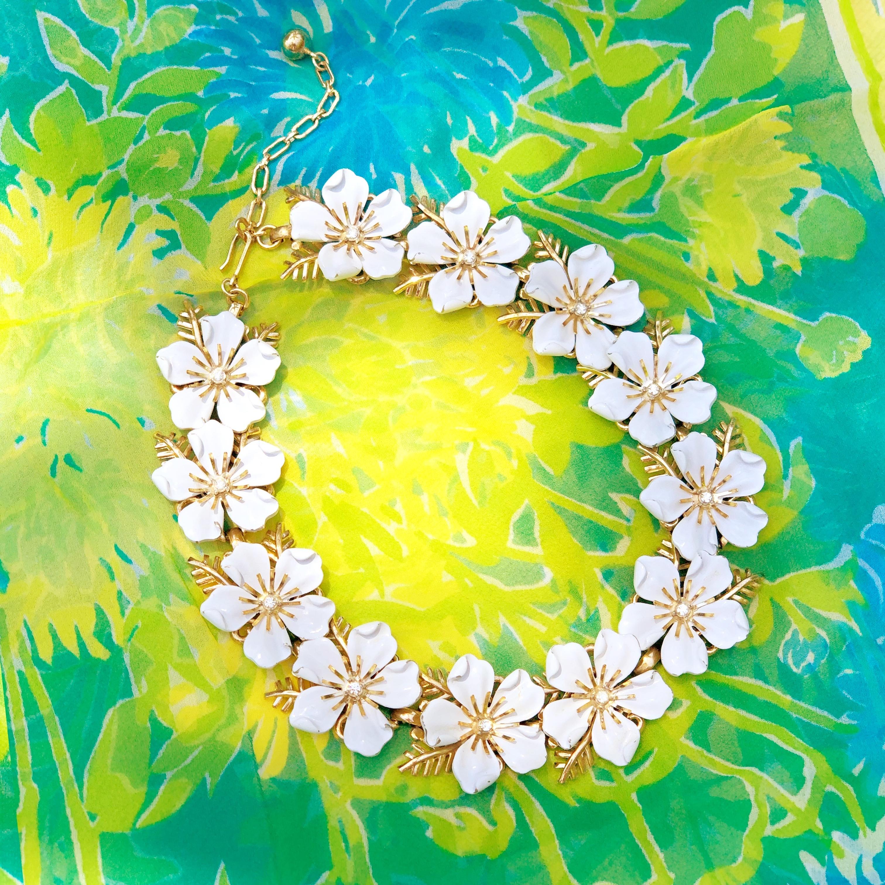 Gorgeous rare gold-plated and white enamel flower choker necklace with crystal rhinestone accents by Trifari, circa 1960s. Trifari is a highly collected costume jewelry brand, noted for its quality and intricate details. This mid-century modern