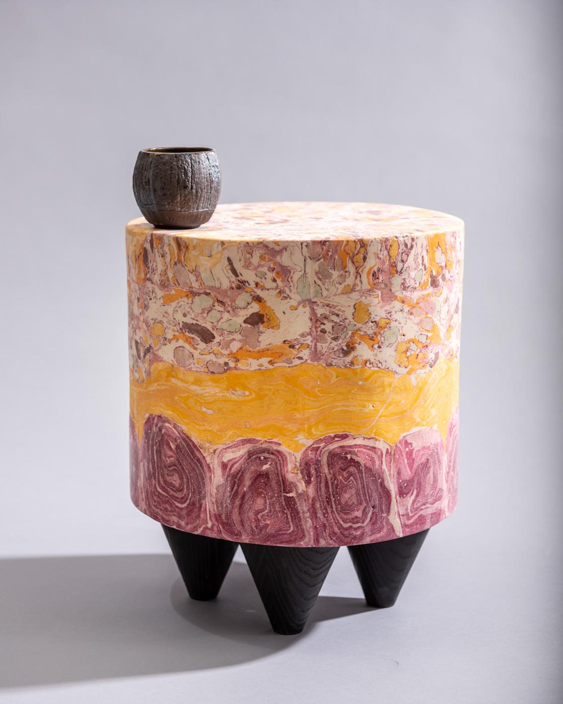 Trifle stool, a layered Scagliola cylinder resembling the sponge, jam, jelly, custard, cream, sprinkles and sherry of Nan’s traditional Christmas trifle, on a set of black ebonized conical ash feet.

Developed in the studio of artists Ivan Morison