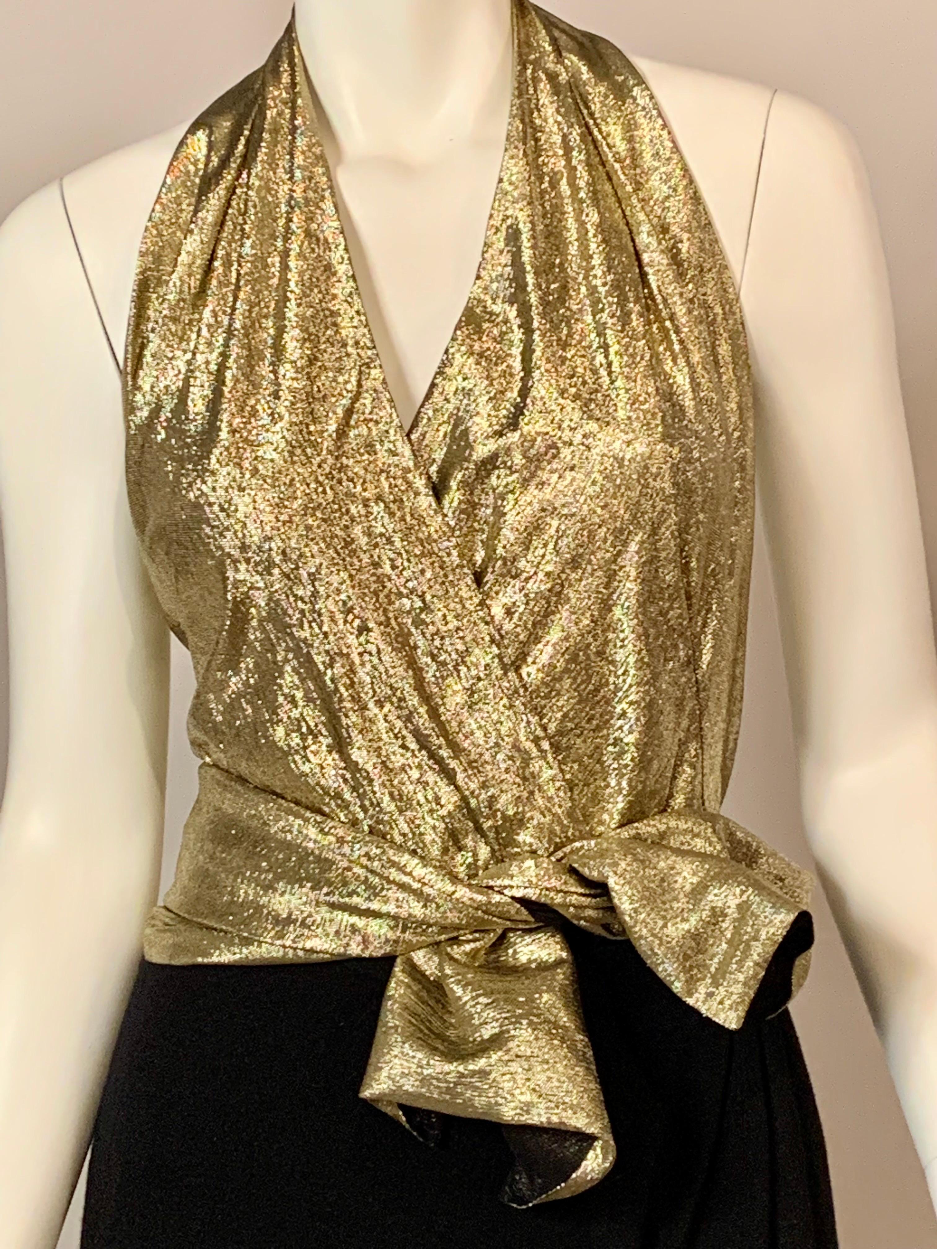 This is a stunning set from Pauline Trigere consisting of a gold halter neck bare back body suit, a matching gold sash, a black wool faux wrap skirt with a high opening in the front., and a matching black wool cape with a tie at the neckline. The