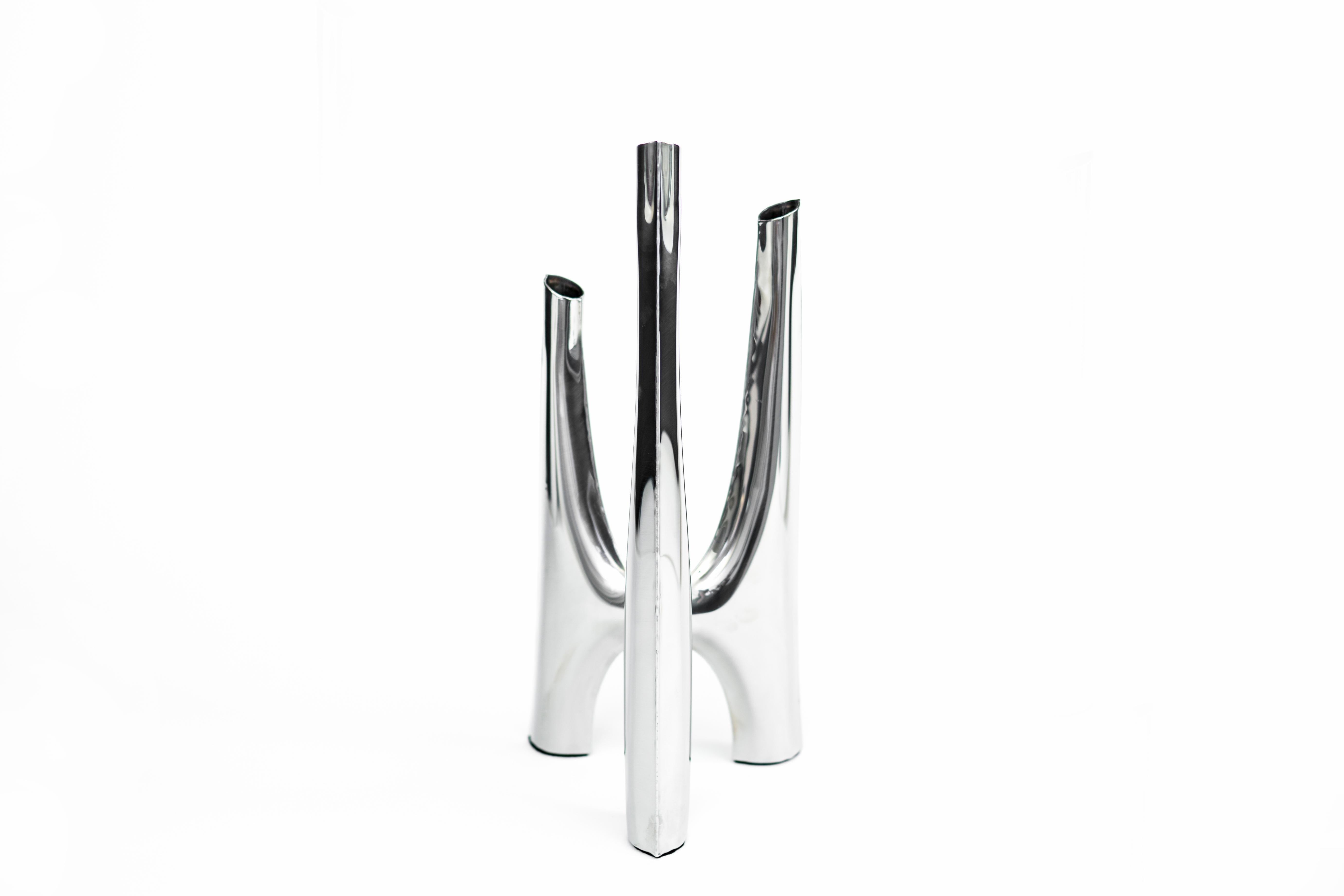 Triglav 41 candleholder by Zieta
Dimensions: W 19 x H 41 cm 
Material: Stainless steel. 
Finish: Polished. 
Available also in a larger version. Candles included.


Triglav is a steel candle holder from Zieta Studio, designed by Oskar Zieta and