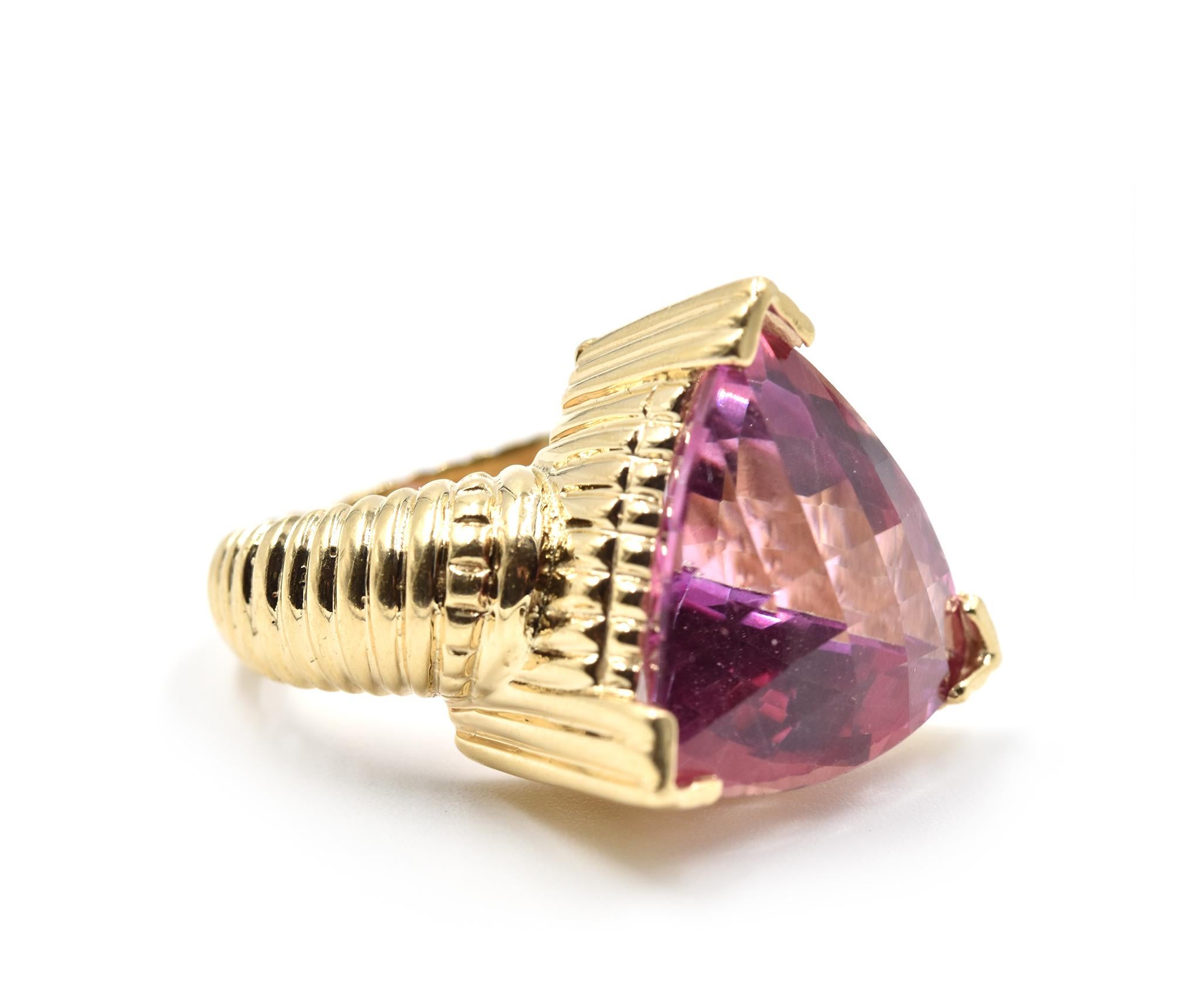 Designer: custom design
Material: 14k yellow gold
Center Stone: trilliant cut pink tourmaline
Dimensions: ring is 3/4-inch long and 3/4-inch wide
Ring Size: 5 1/4 (please allow two additional shipping days for sizing requests)
Weight: 19.20 grams
