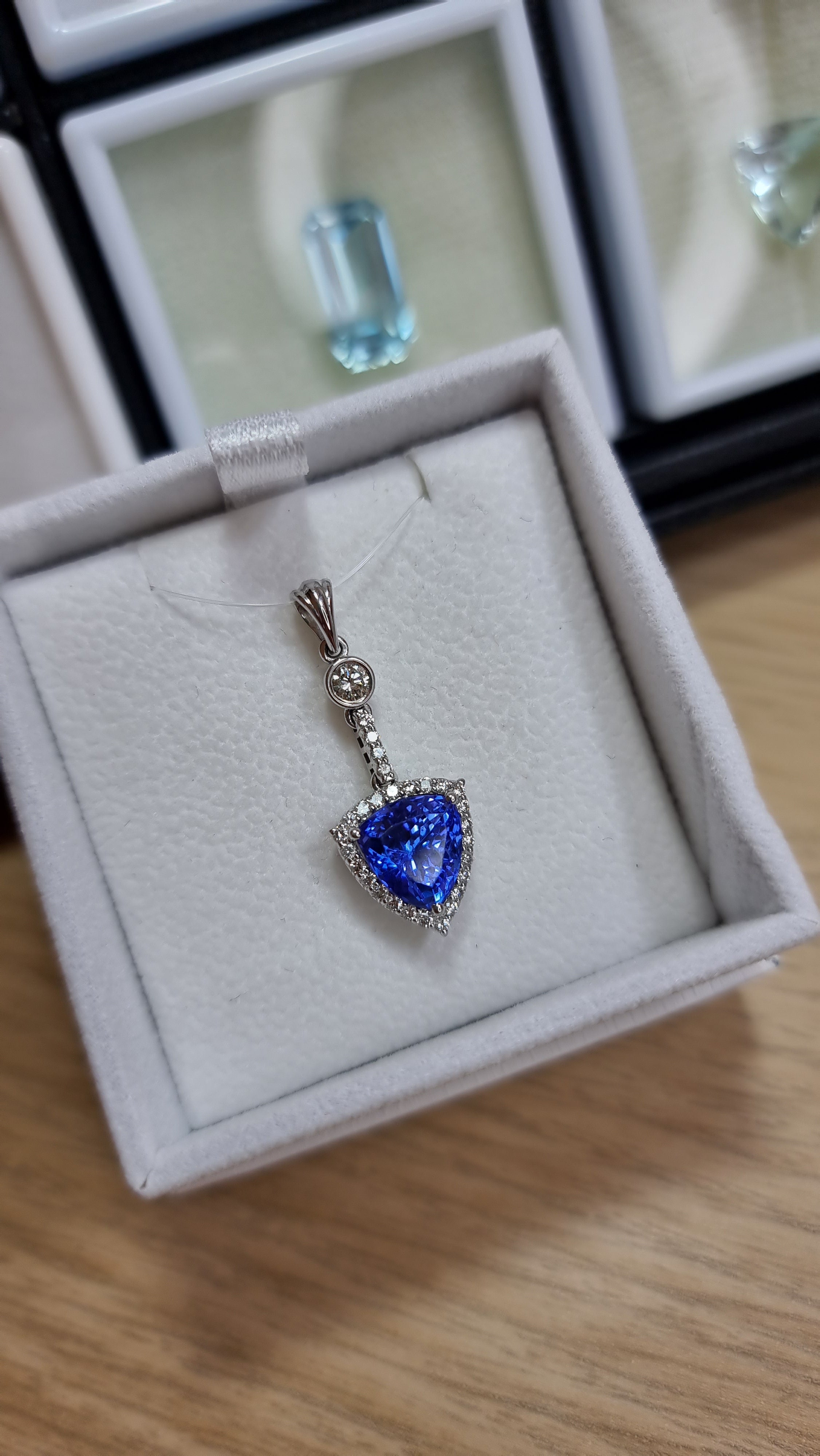 Stunning natural Tanzanite with vivid blue hue. Tanzanite is an incredibly rare gemstone currently only mined in one location in the world, Arusha in Tanzania. The blue Tanzanite is perfectly set in a stunning cluster halo of natural diamonds and