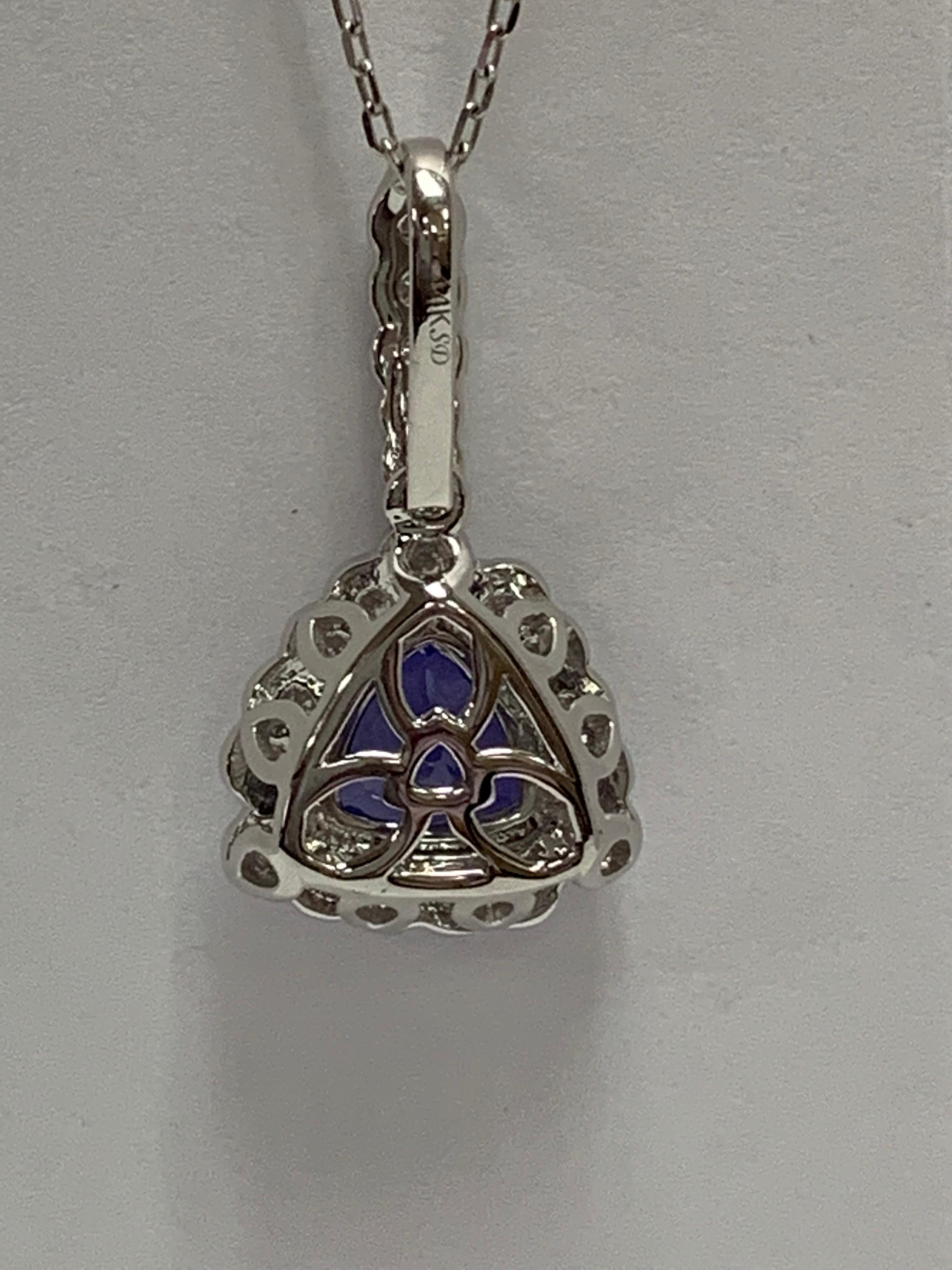 Trillion 1.02 Carat Tanzanite and 0.42 Carat white round  diamond set in 14 Karat white gold is one of a kind  hand crafted Pendant. The Pendant include 18 Inches chain.