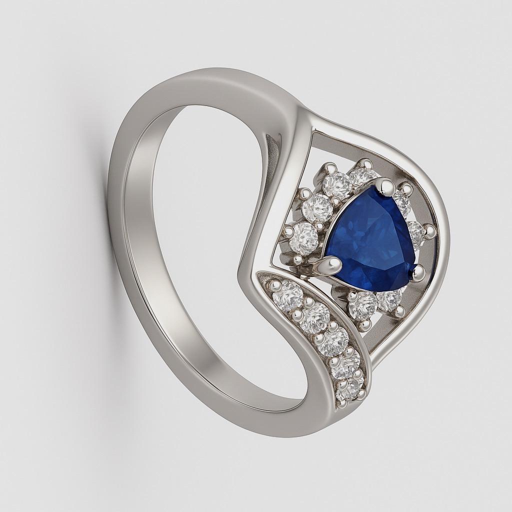 This 6.8mm x 6.6mm Statement Ring features a 1ct trillion-cut blue sapphire as its centerpiece. The trillion cut, a triangular faceting style, enhances the sapphire’s deep blue color and brilliance through its unique geometry, making it a standout