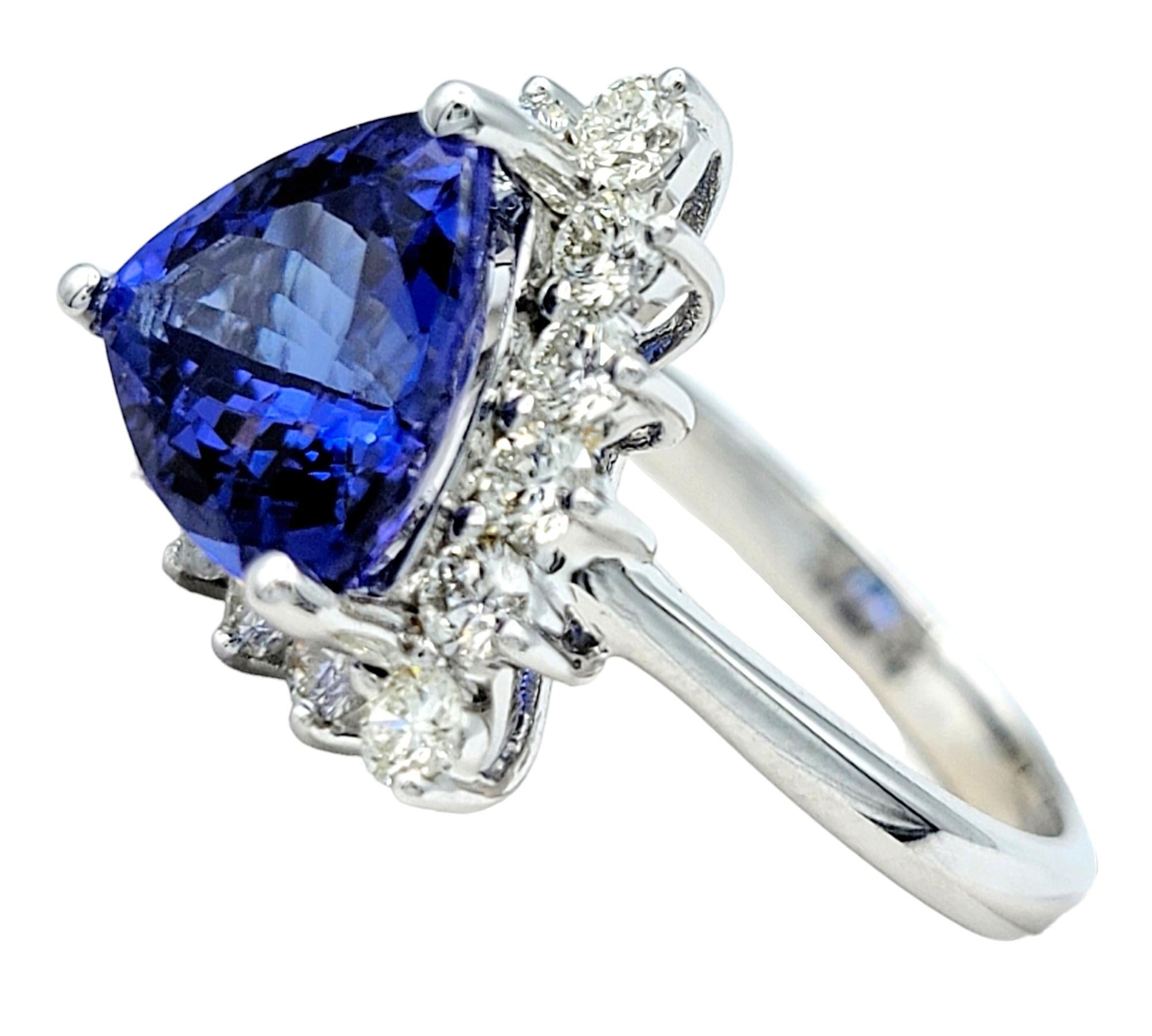 Contemporary Trillion Cut Blue Tanzanite and Round Diamond Halo Ring in 14 Karat White Gold For Sale