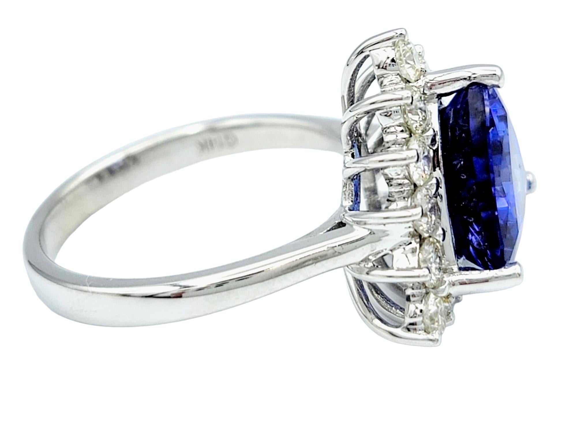 Trillion Cut Blue Tanzanite and Round Diamond Halo Ring in 14 Karat White Gold In Good Condition For Sale In Scottsdale, AZ