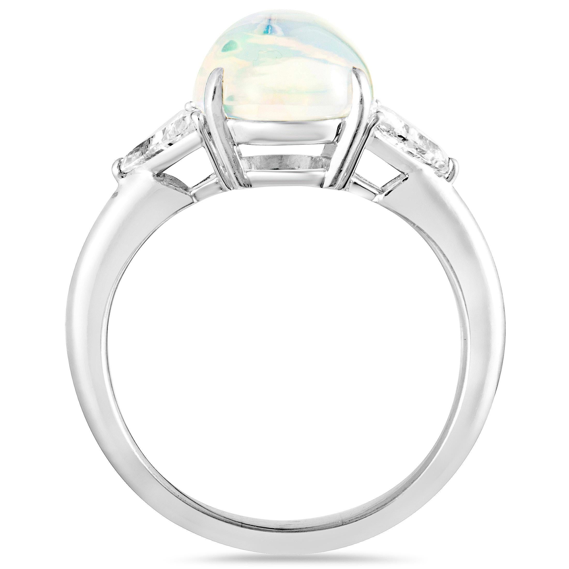 An exceptionally elegant look is achieved in this beautiful jewelry piece by combining the sublime allure of opal with the scintillating brilliance of diamonds. The ring is expertly crafted from luxurious platinum and it is set with an opal that