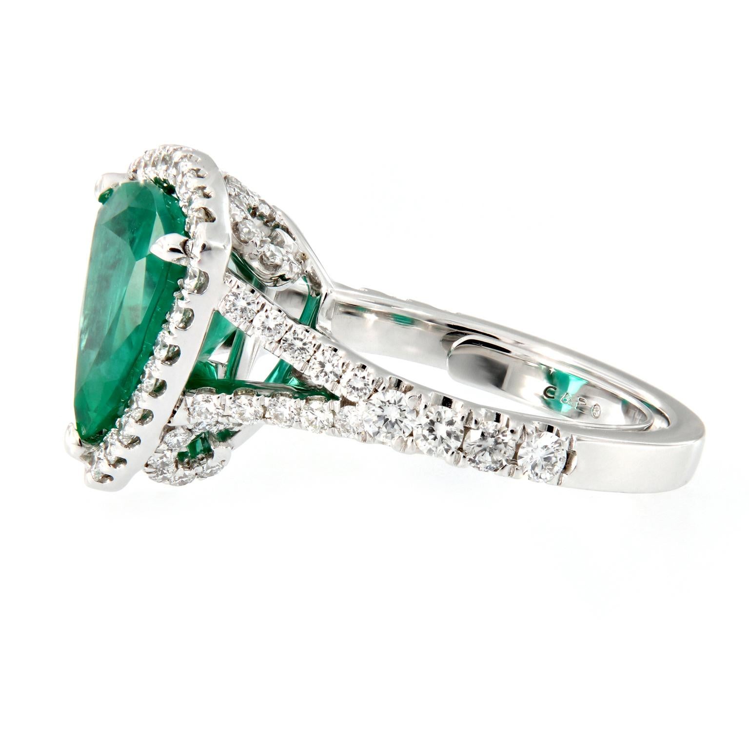 Modern and strikingly unique, this trillion cut emerald ring is sure to stand out. The center stone is a 3.88 carat Zambian emerald beautifully accented with 1.0 cttw of VVS, E RBC diamonds set in 18k white gold. 

Ring Size 6.5.
