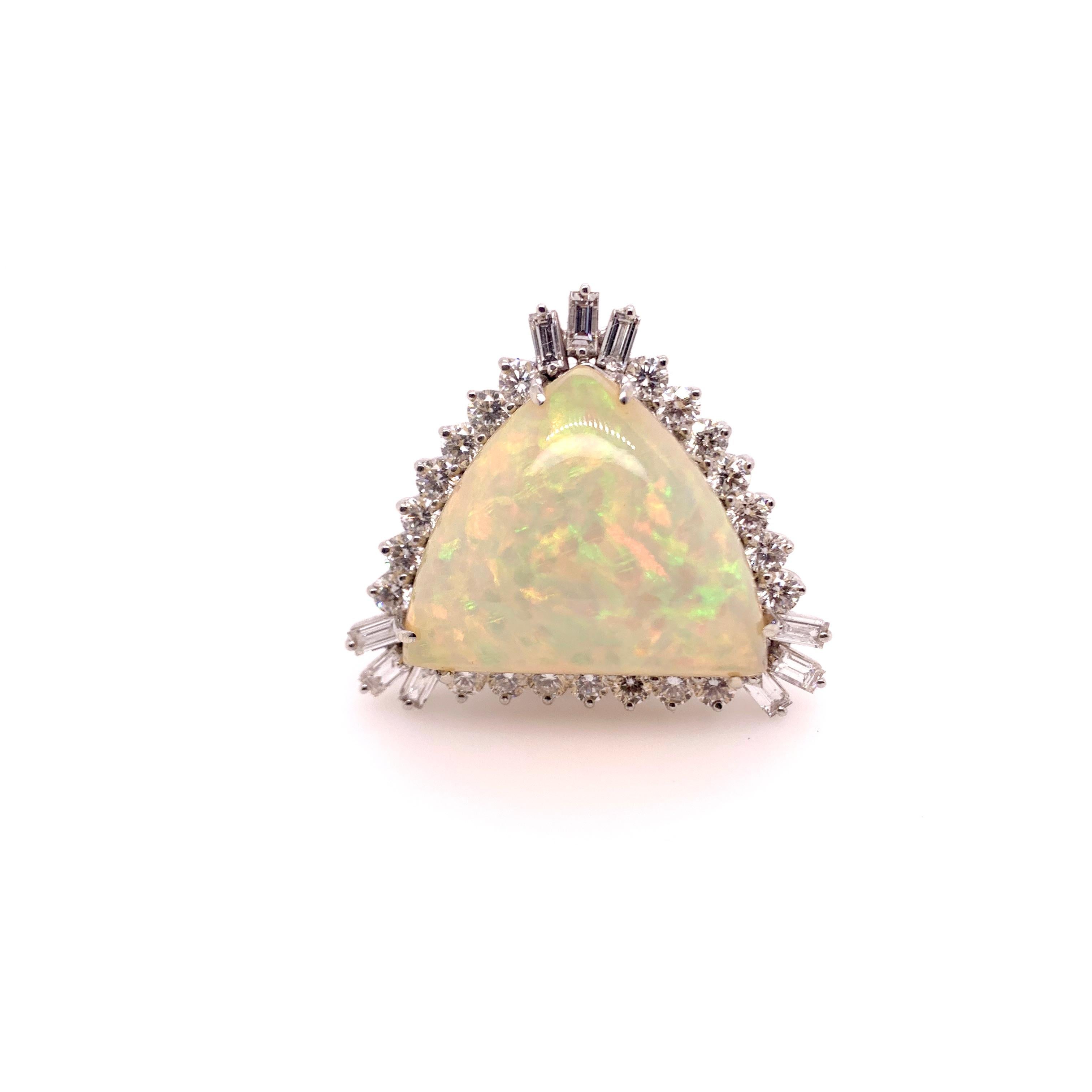 This impressive Ethiopian Opal will sit boldly on your hand with it's massive size and custom made diamond setting.  The trillion shaped opal has enormous colortones and the round brilliant and baguette diamonds accentuate the opal.   The large