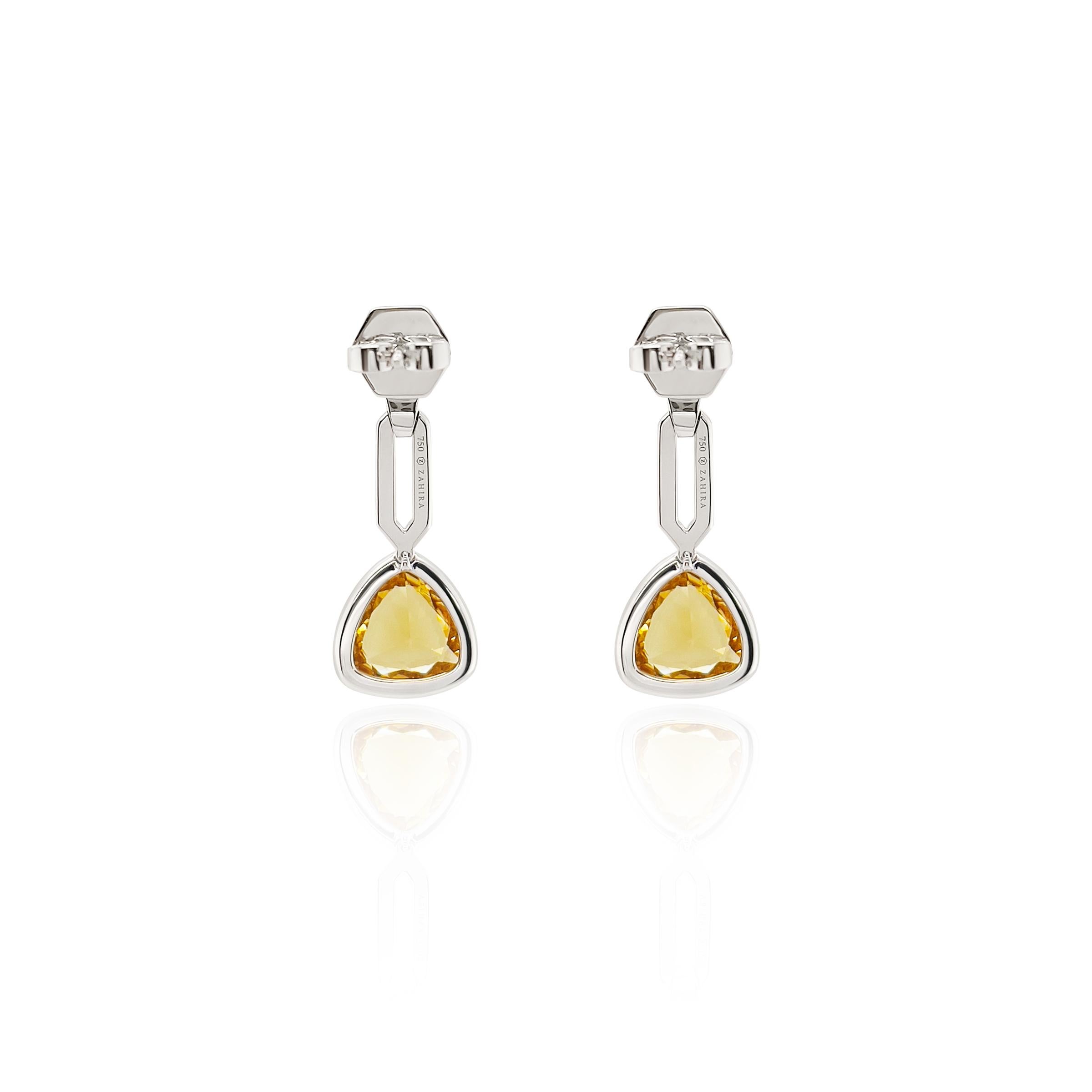 This beautiful yellow and golden stone is a Helidor which is a rare gemstone and in the beryl family 
( like an emerald ). This rare 3.97ct pair of Helidor earrings are natural and have not been color treated. Designed into dangle earrings and a