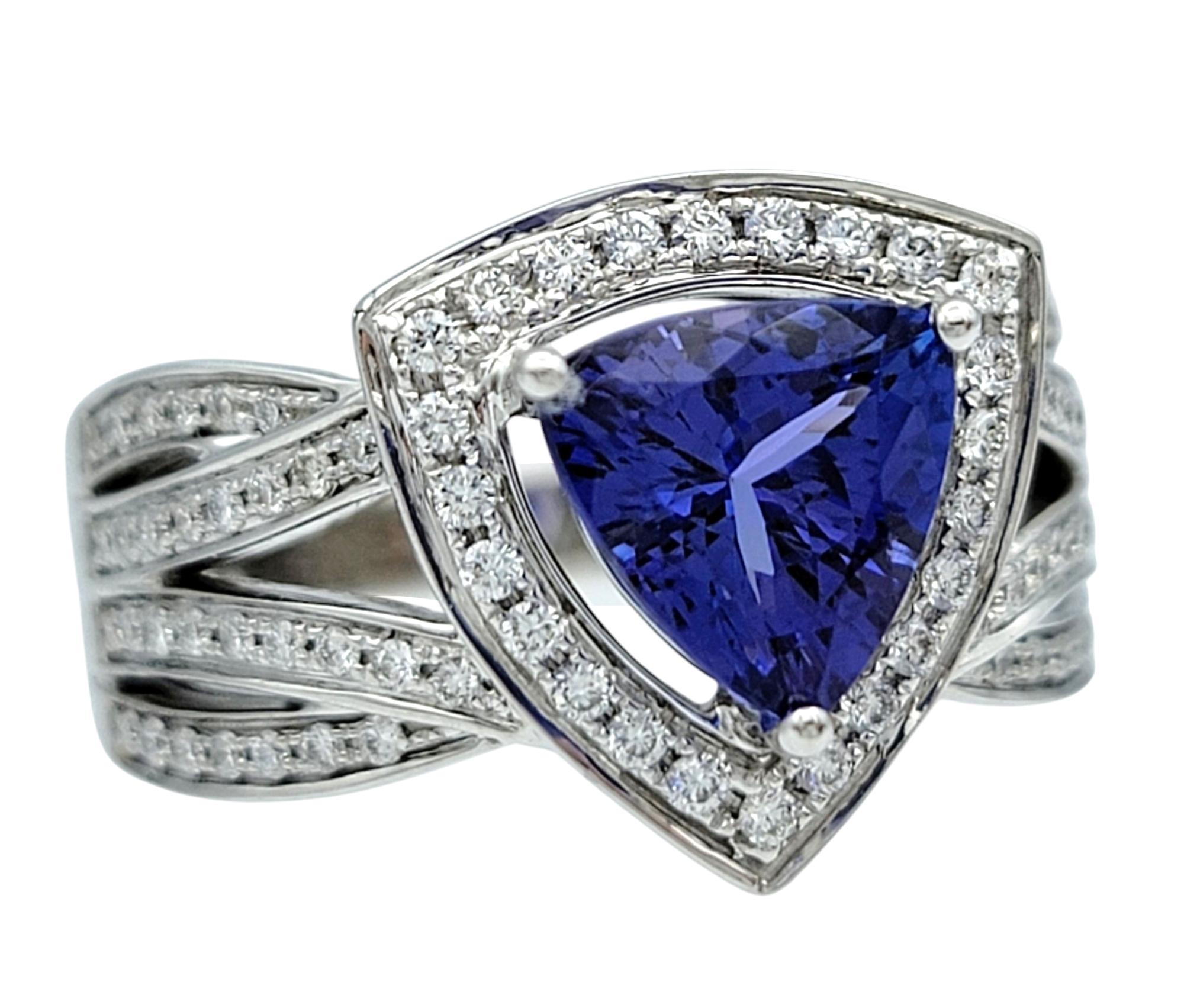 Ring Size: 7

Elevate your jewelry collection with this captivating tanzanite and diamond ring, a masterpiece of modern elegance. At its heart lies a mesmerizing trillion-cut tanzanite, showcasing a vivid violet-blue hue that captures the essence of