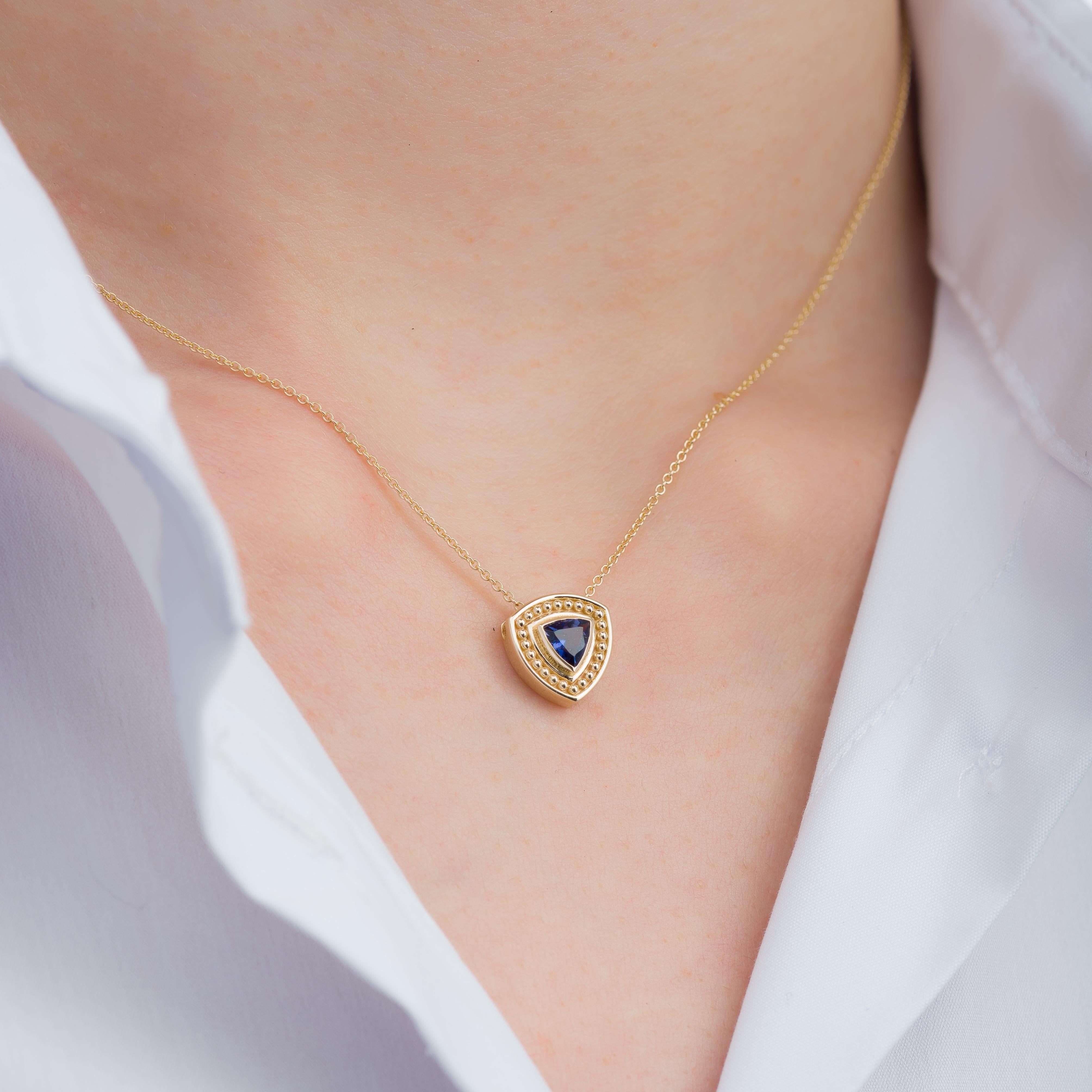 Embrace the captivating allure of our gold pendant, showcasing the enchanting elegance of a trillion-cut iolite—a genuine testament to timeless sophistication and the beauty of nature's gems.

100% handmade in our workshop.

Metal: 18K
