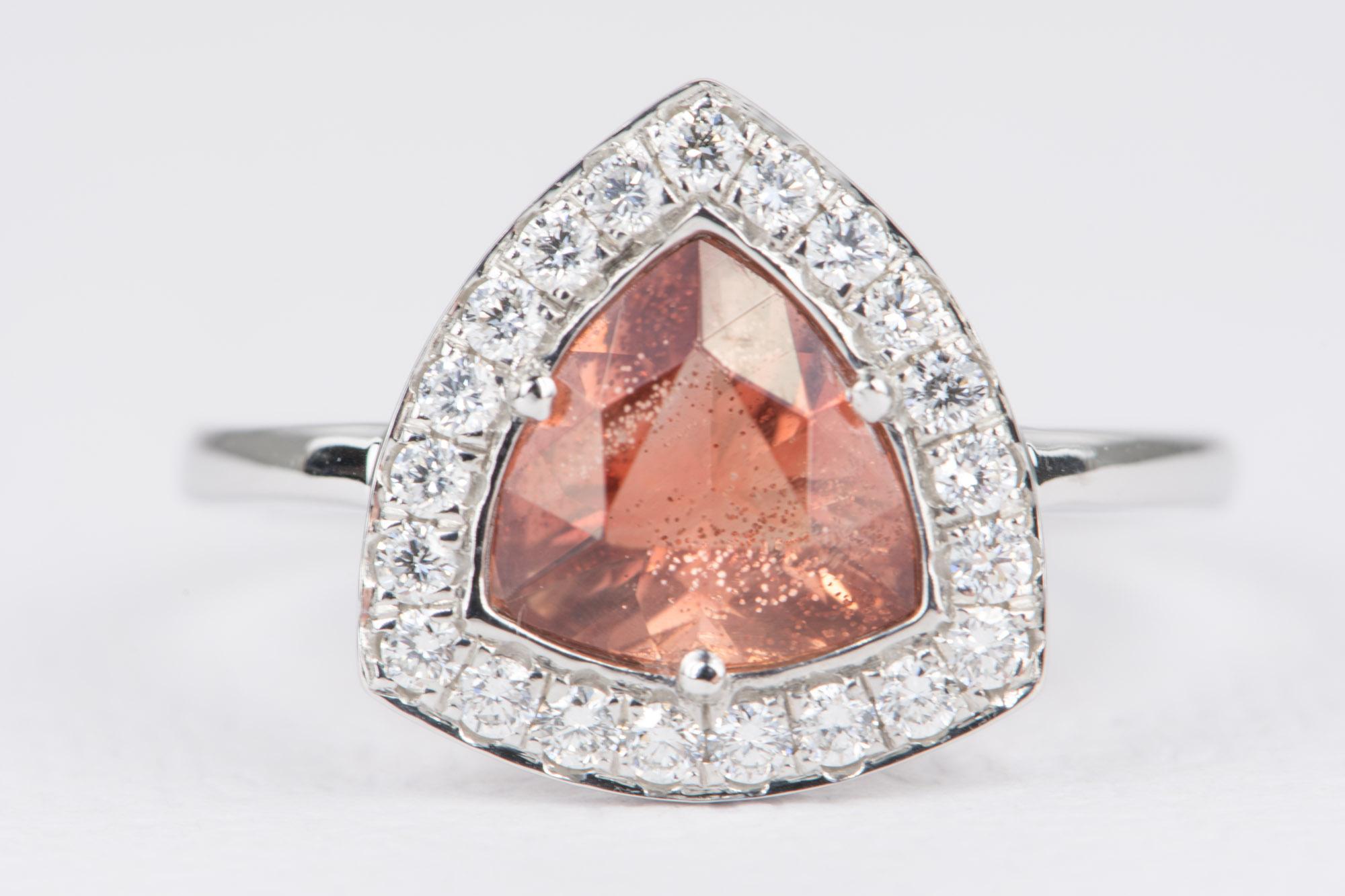 ♥  Solid 14K gold ring set with a trillion shape Oregon sunstone, surrounded by a halo of natural white diamonds, adding to the sparkle factor!
 ♥  The beautiful sunstone has really beautiful schillers inside! They contrast really nicely with the