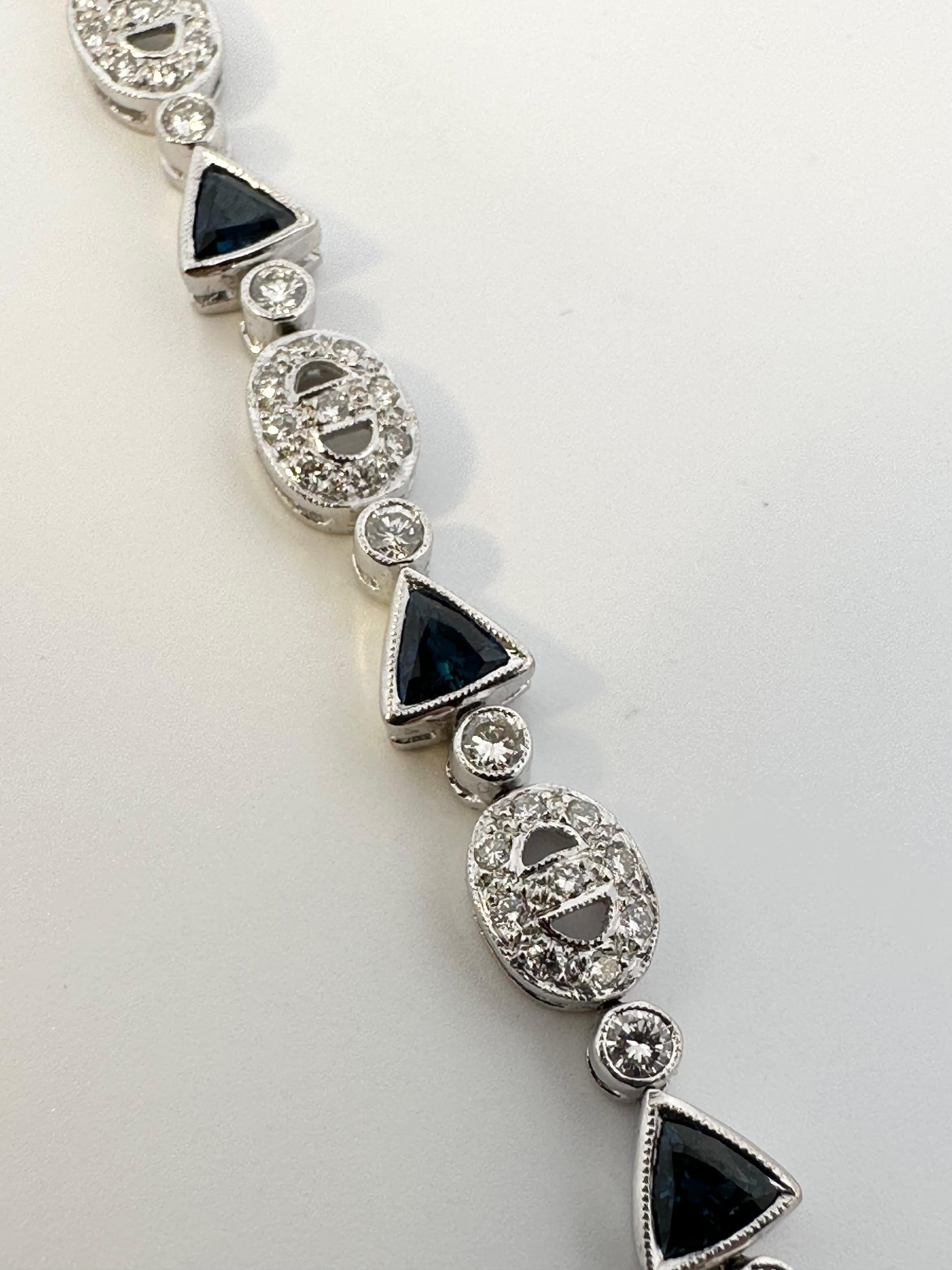 One 18kt white gold bracelet set with trillion cut natural blue sapphires and brilliant cut diamonds. Perfect for everyday with a little splash of colour. 

11 trillion cut natural blue sapphires weighing 2.75ct total weight

121 brilliant cut
