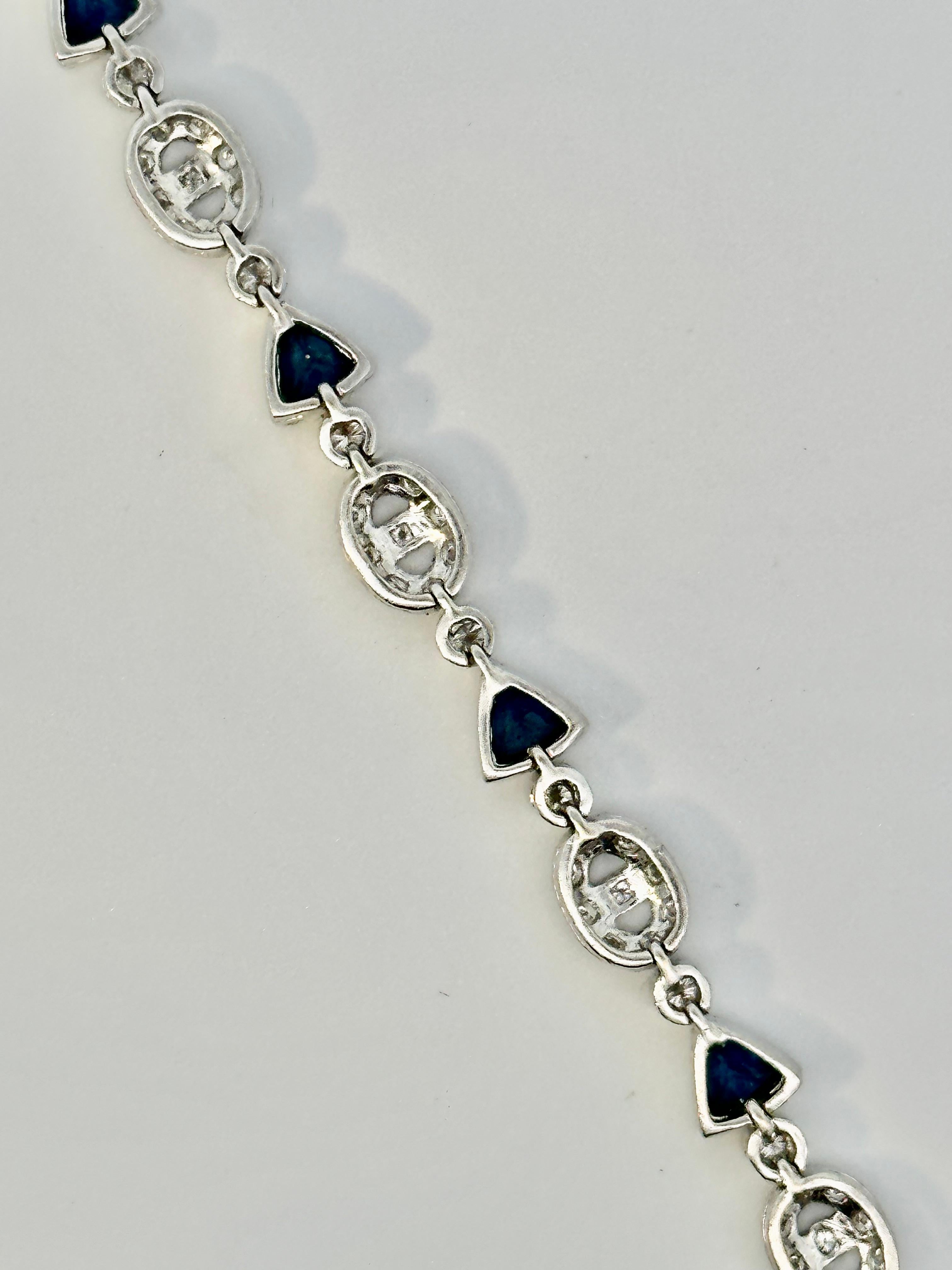 Contemporary Trillion Sapphire and Oval Motif Diamond Bracelet on 18 Karat White Gold For Sale