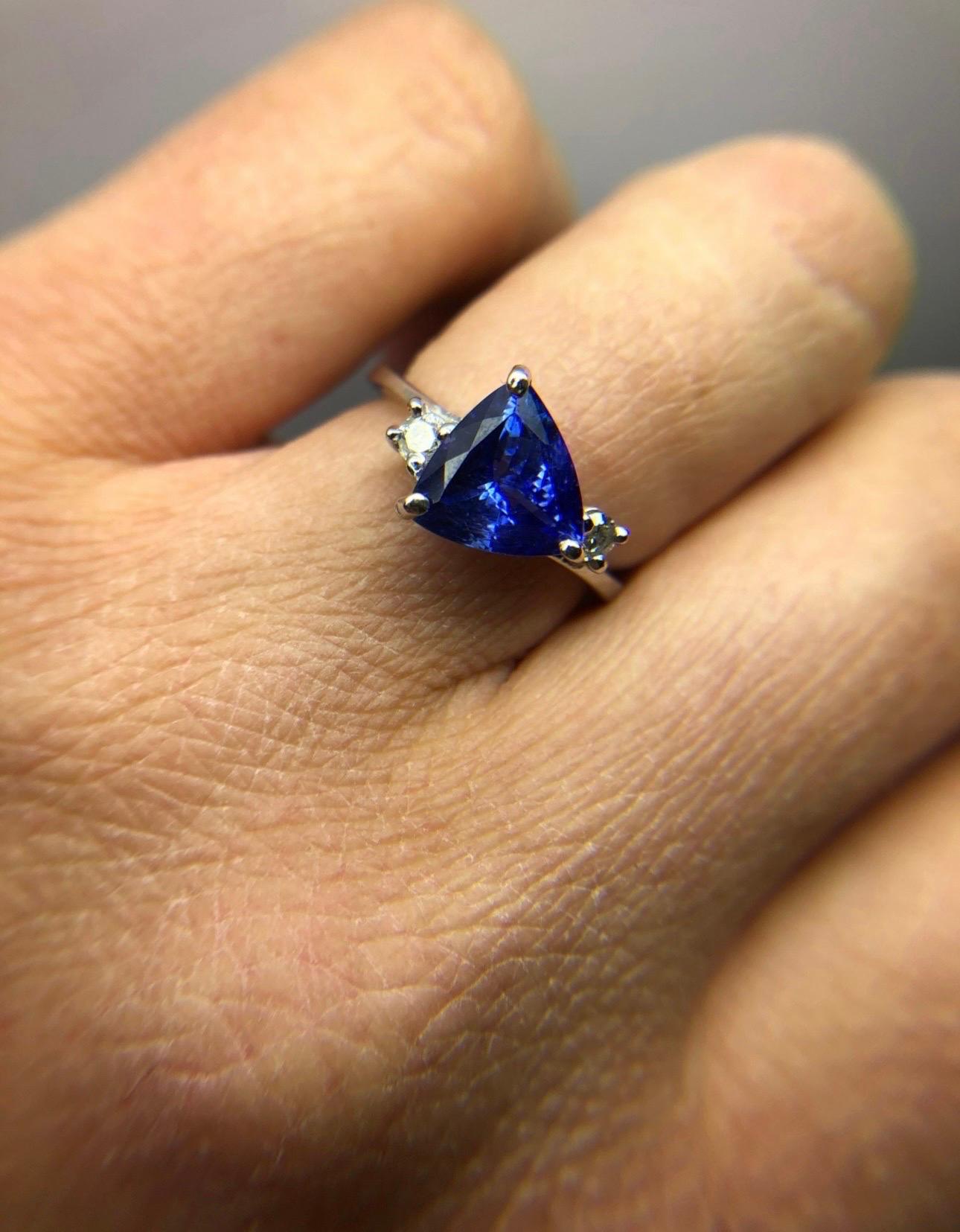 Trillion tanzanite deep violet color totalling 2 carats accompanied by diamonds VS clarity and F color, the ring is modern and classical at the same time. Size 6. Can be re-sized. Comes with beautiful packaging and appraisal.

Certificate of