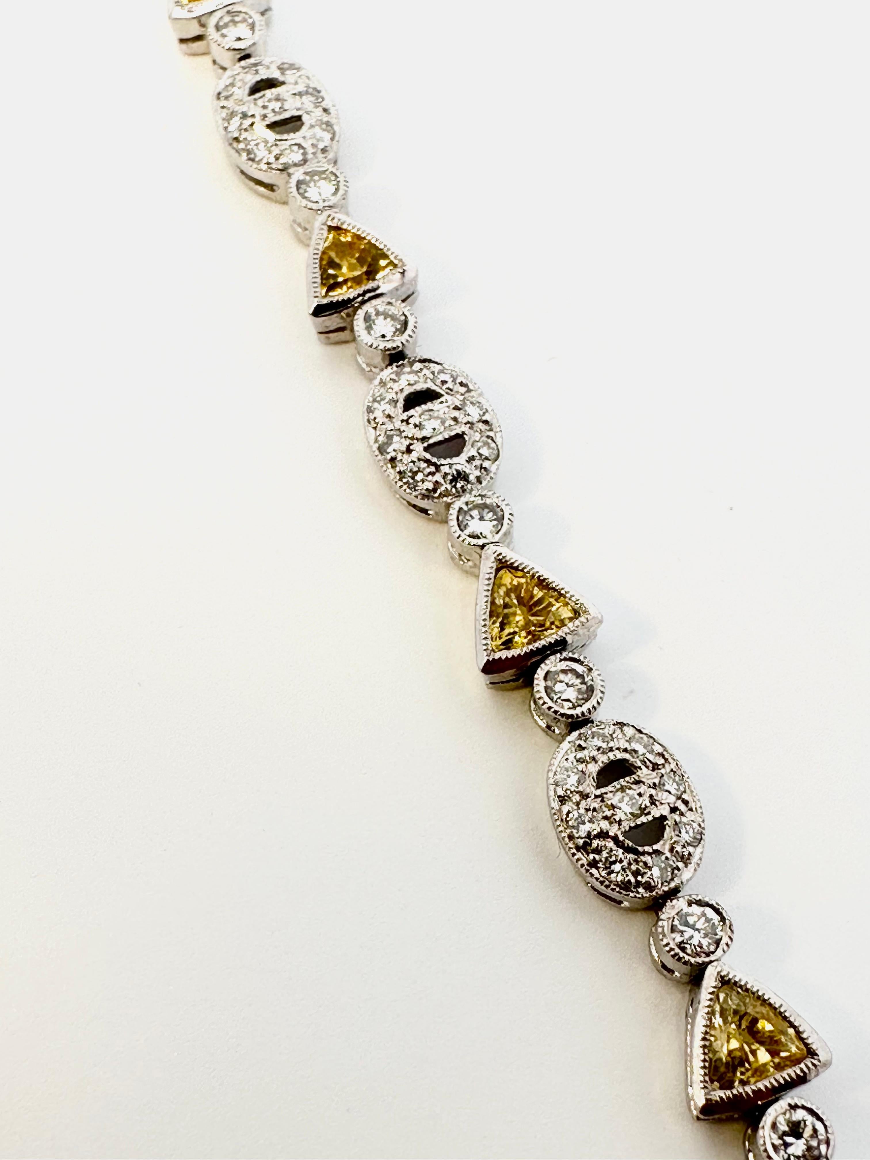 One 18kt white gold bracelet set with trillion cut natural yellow sapphires and brilliant cut diamonds. Perfect for everyday with a little splash of colour. 

10 trillion cut natural yellow sapphires weighing 2.50ct total weight

110 brilliant cut