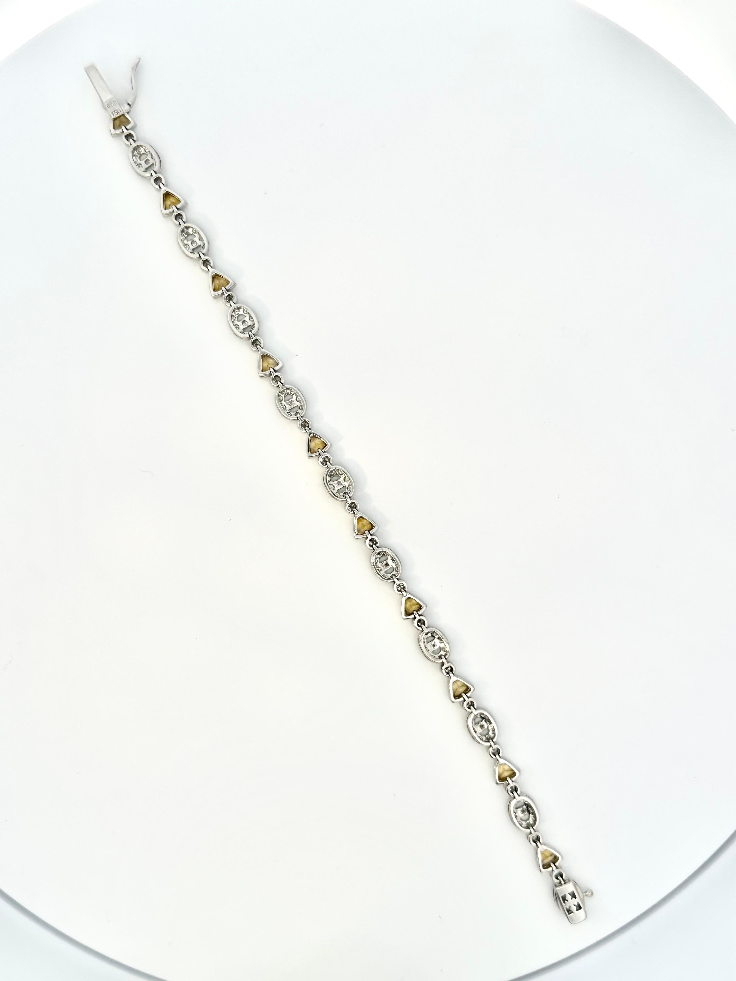 Contemporary Trillion Yellow Sapphire and Oval Motif Diamond Bracelet on 18 Karat White Gold For Sale