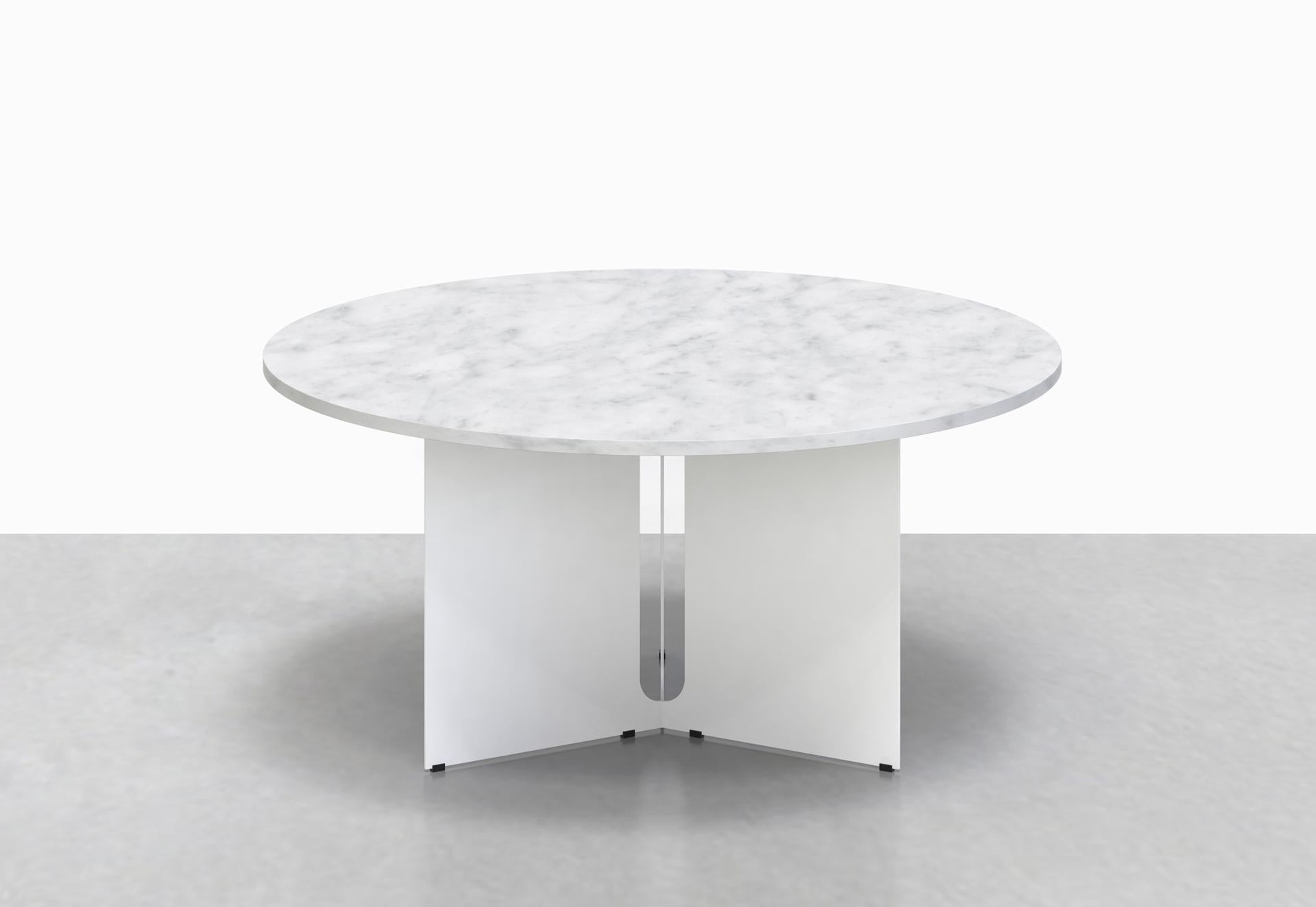 Our Trilo round table is polished but unpretentious. Choose between a solid walnut or variegated white marble top, anchored by a steel base with a playful geometrical cut-out detail. 