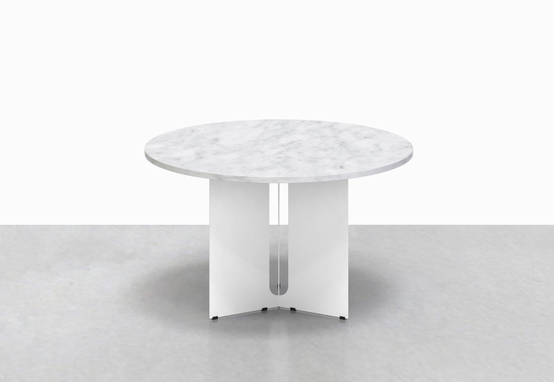 Our Trilo round table is polished but unpretentious. Choose between a solid walnut or variegated white marble top, anchored by a steel base with a playful geometrical cut-out detail.