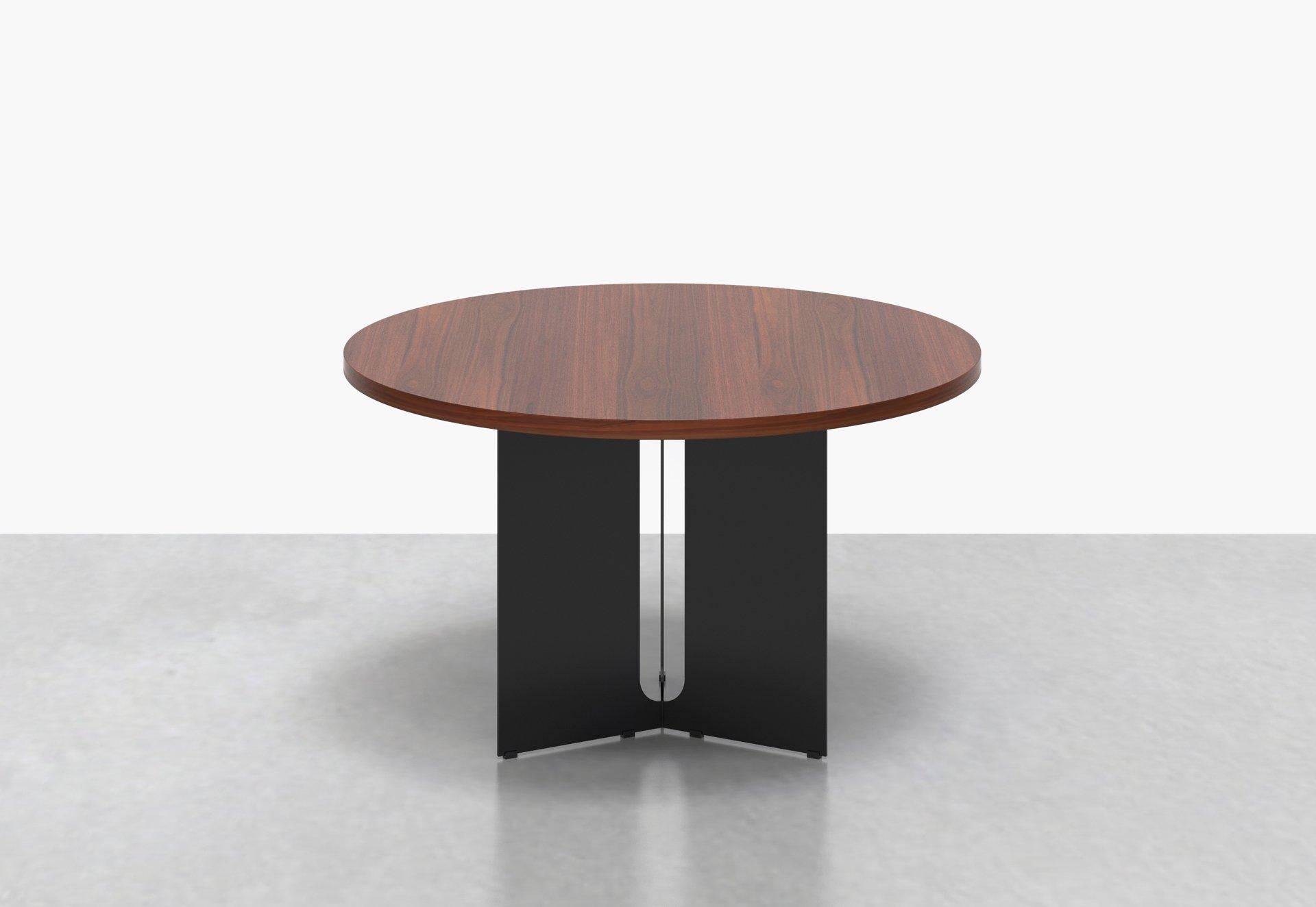 Our Trilo round table is polished but unpretentious. Choose between a solid walnut or variegated white marble top, anchored by a steel base with a playful geometrical cut-out detail. Measures: 48