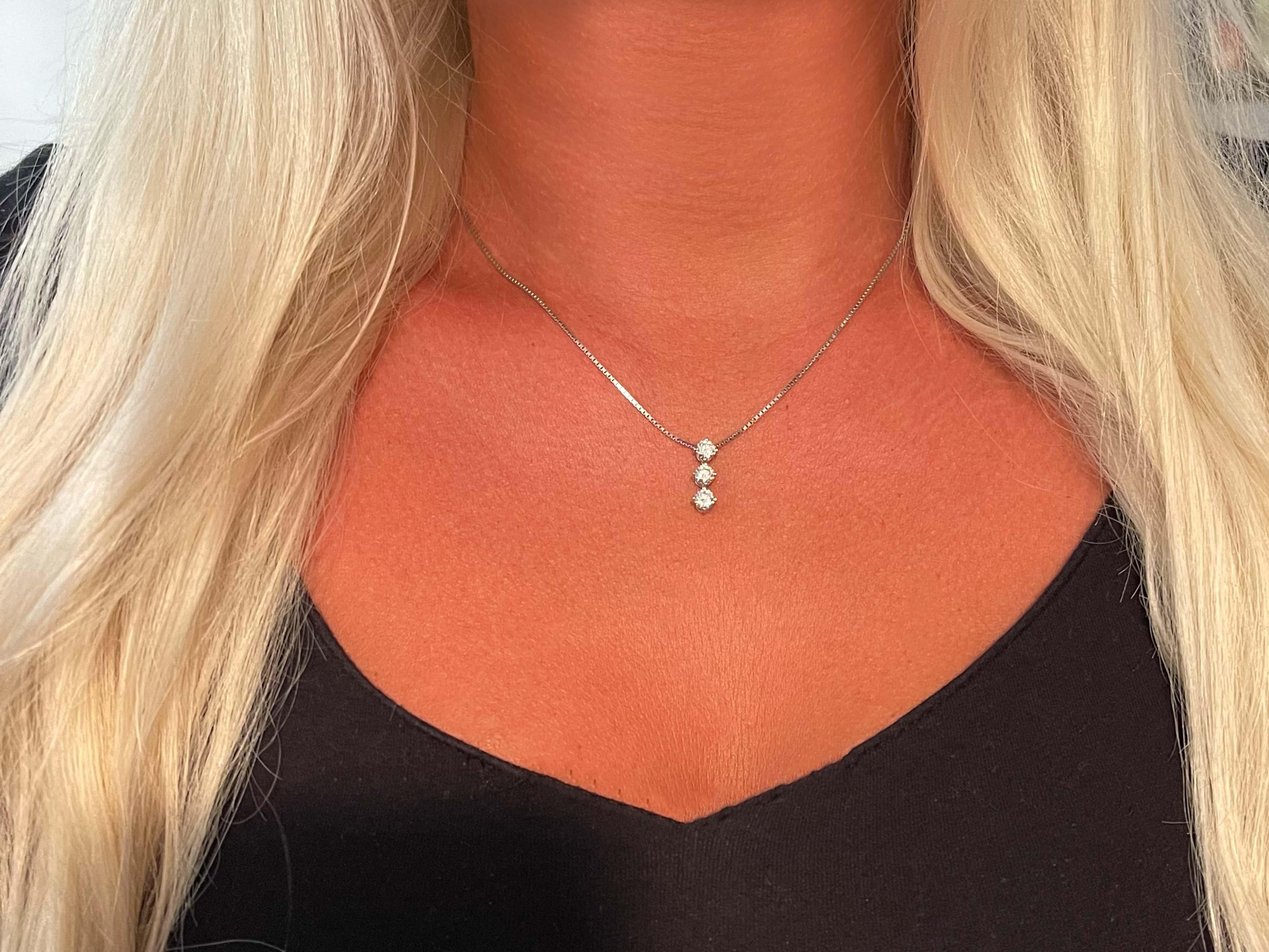 Trilogy 3 Diamond Drop Necklace in Platinum. The 3 round brilliant cut diamonds are G in color with the top diamond SI2 in clarity and the two below, SI1. The diamonds weigh a total of 1.09 carats and have amazing sparkle. Each diamond has its