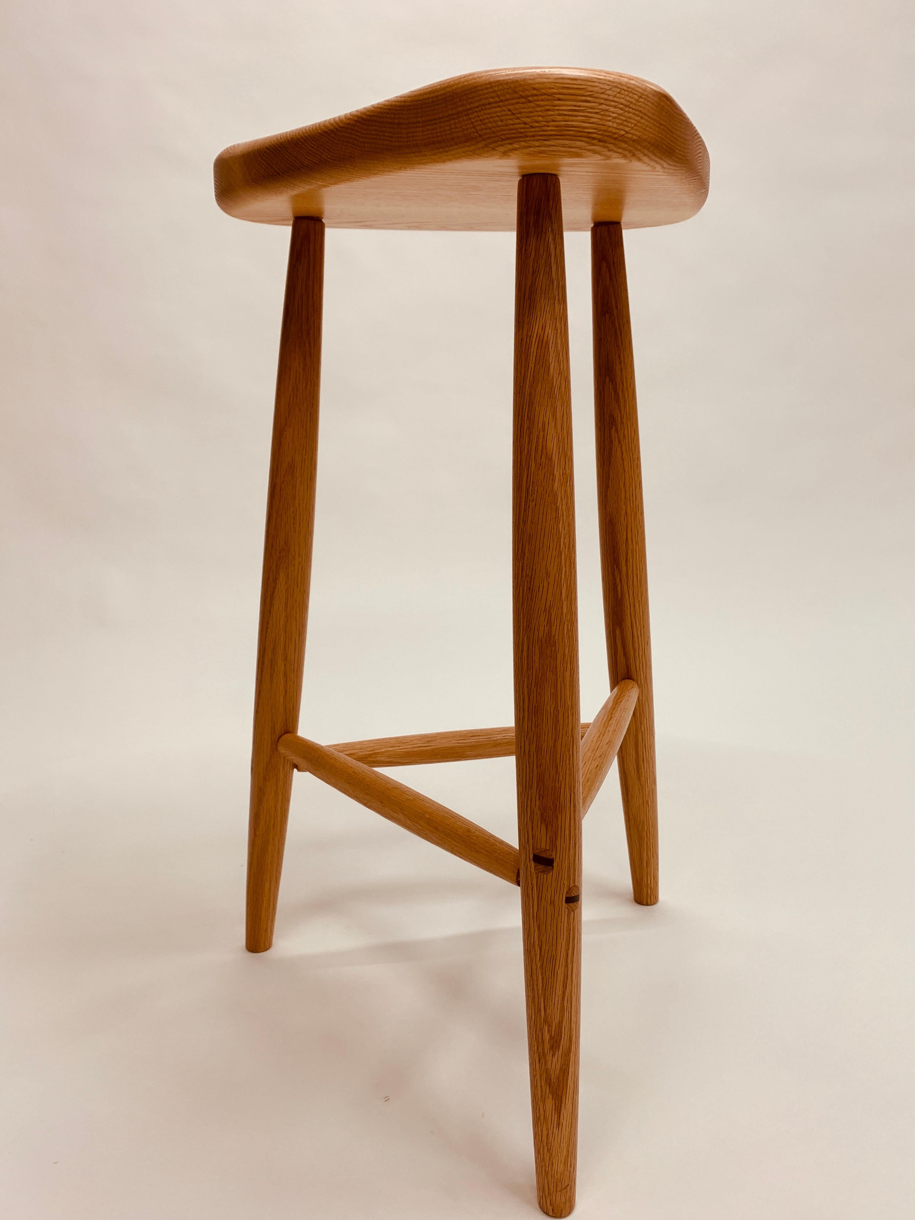 Trina est un tabouret classique pour le comptoir de votre cuisine.  Il est proposé en chêne ou en cerisier et mesure 27 pouces de haut.  Les tenons traversants sont fixés à l'aide de cales.  Le siège profilé offre un confort dans plusieurs