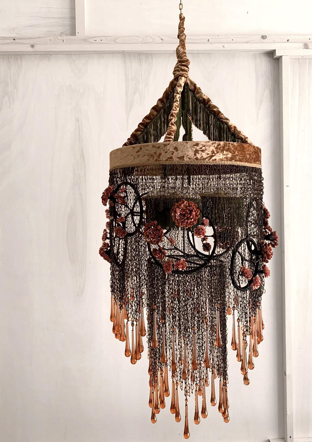 Trina Chandelier by Valentina Giovando
Dimensions: D 60 x H 120 cm.
Materials: Iron, Glass, Sequins, Fabric. 

Valentina Giovando, Lives and works in Sarzana, in Liguria, and for over 20 years she dedicated herself to the production of a new style.
