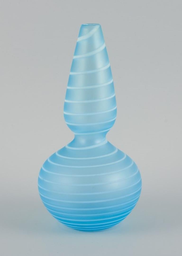 Trine Drivsholm, contemporary Danish glass artist.
Unique hand-blown art glass vase in light blue with white stripes.
2000.
In perfect condition.
Engraved artist's signature.
34/150.
Dimensions: H 22.5 x D 11.5 cm.