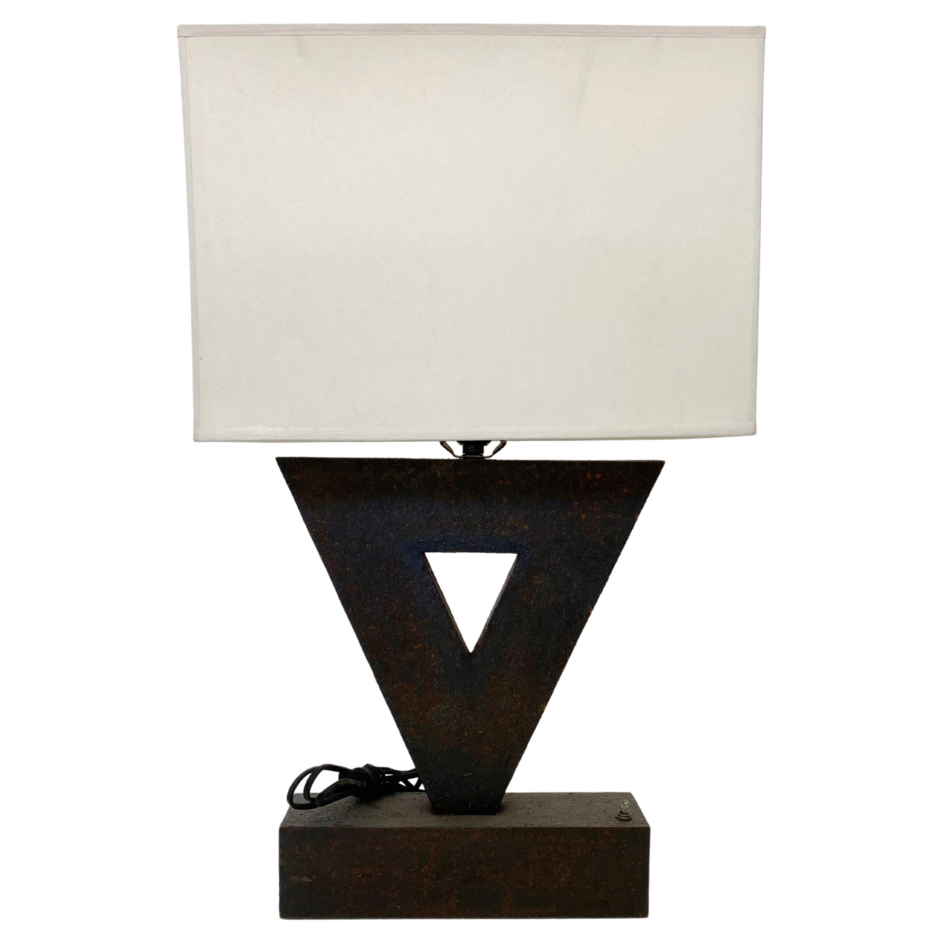 Custom made triangular oxidized iron table lamp designed by Juan Montoya. This geometric piece will add a unique look to any room. 

Property from esteemed interior designer Juan Montoya. Juan Montoya is one of the most acclaimed and prolific