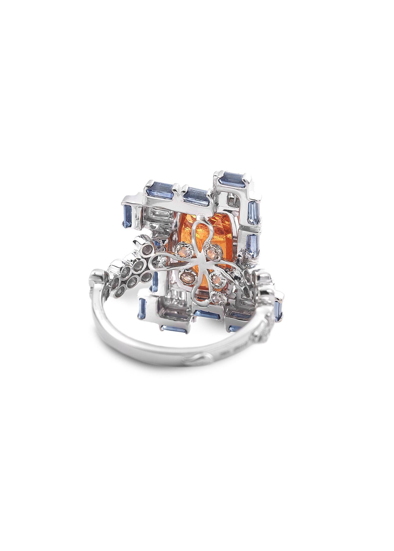 Mandarin Garnet, Diamond and Sapphire ring. Mandarin Garnet 5.7ct, Blue Sapphire 1.4ct, Diamonds 0.89cts.
SIZE 7
 