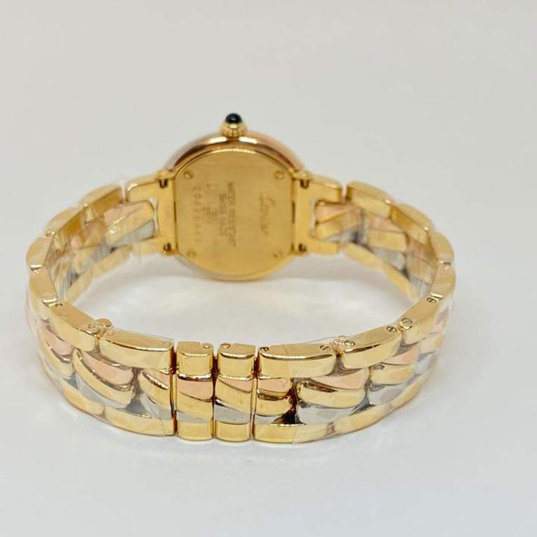 Rare pre-owned Cartier Trinity timepiece designed in solid 18 karat yellow, rose and white gold. The watch measures 27mm, 7