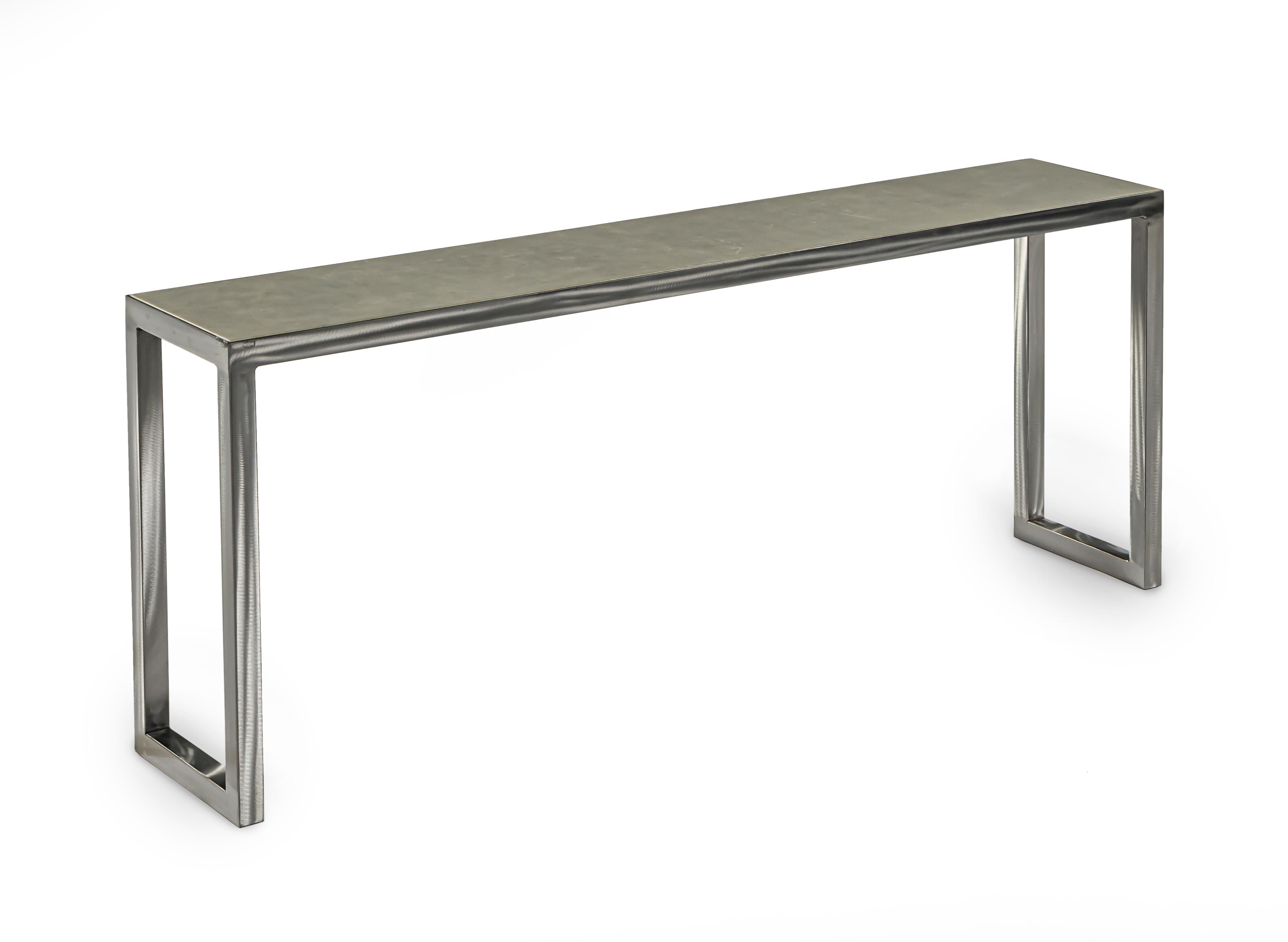 A console table with an unfinished metal structure, table top is finished in a gray leather.