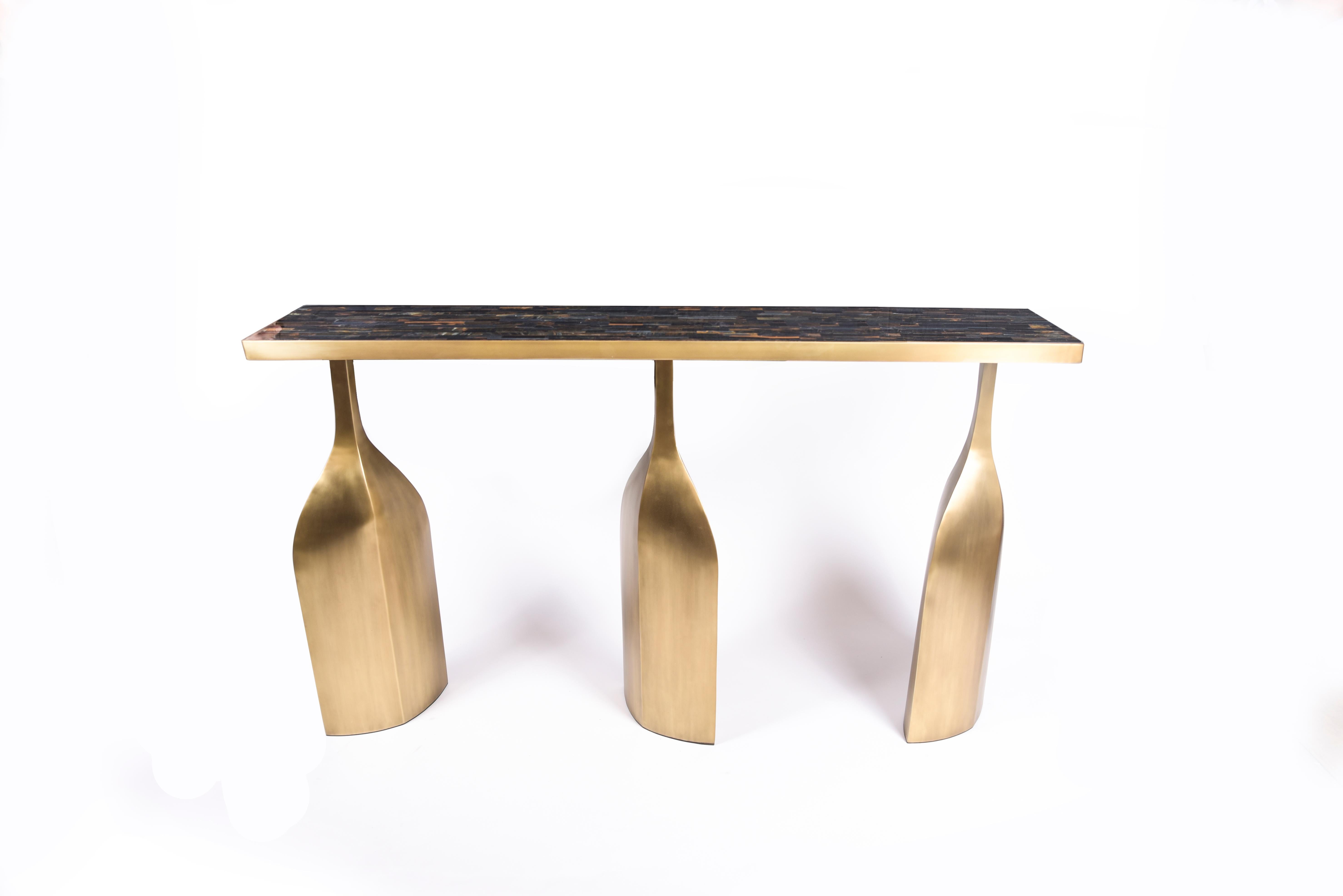 The trinity console is bold and exquisite in design. The top is inlaid in coal black shagreen and sits on three stunning bronze-patina sculptural legs. The top is available in other finishes, see images at end of slide. This piece is designed by