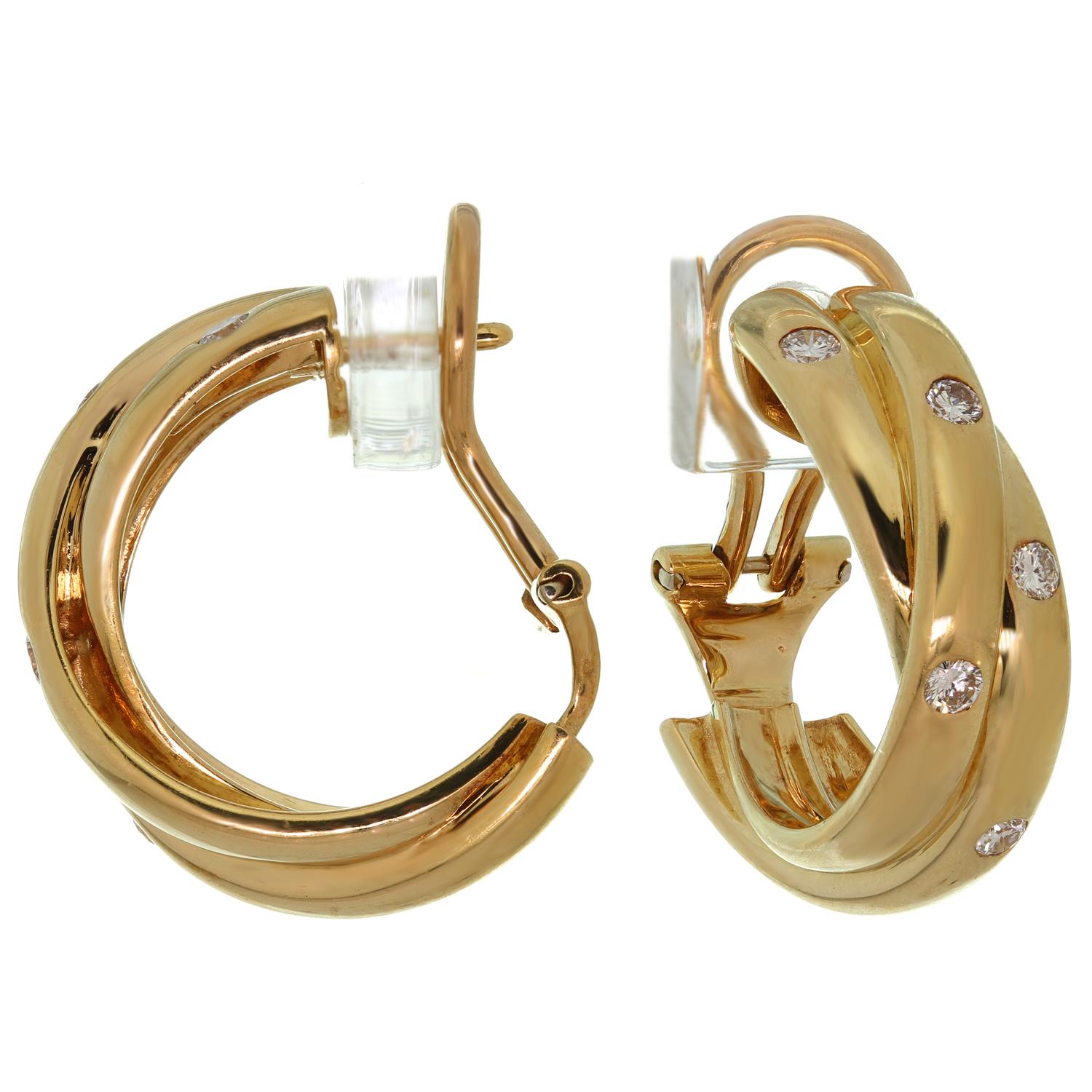 These iconic Cartier hoop earrings from the classic Trinity de Cartier collection are crafted in 18k yellow gold and set with brilliant-cut round G VS diamonds weighing an estimated 0.30 carats. Made in France circa 1990s. Measurements: 0.27