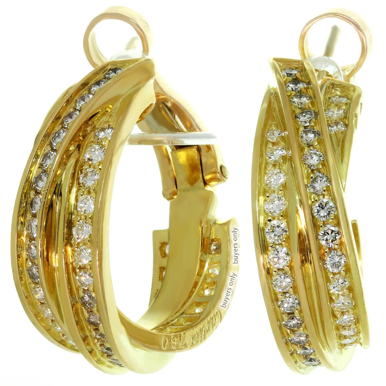 These stunning Cartier earrings from the classic Trinity de Cartier collection feature a half-hoop lever-back design with three interlocking bands crafted in 18k yellow gold and set with high-grade brilliant-cut round diamonds of an estimated 1.23