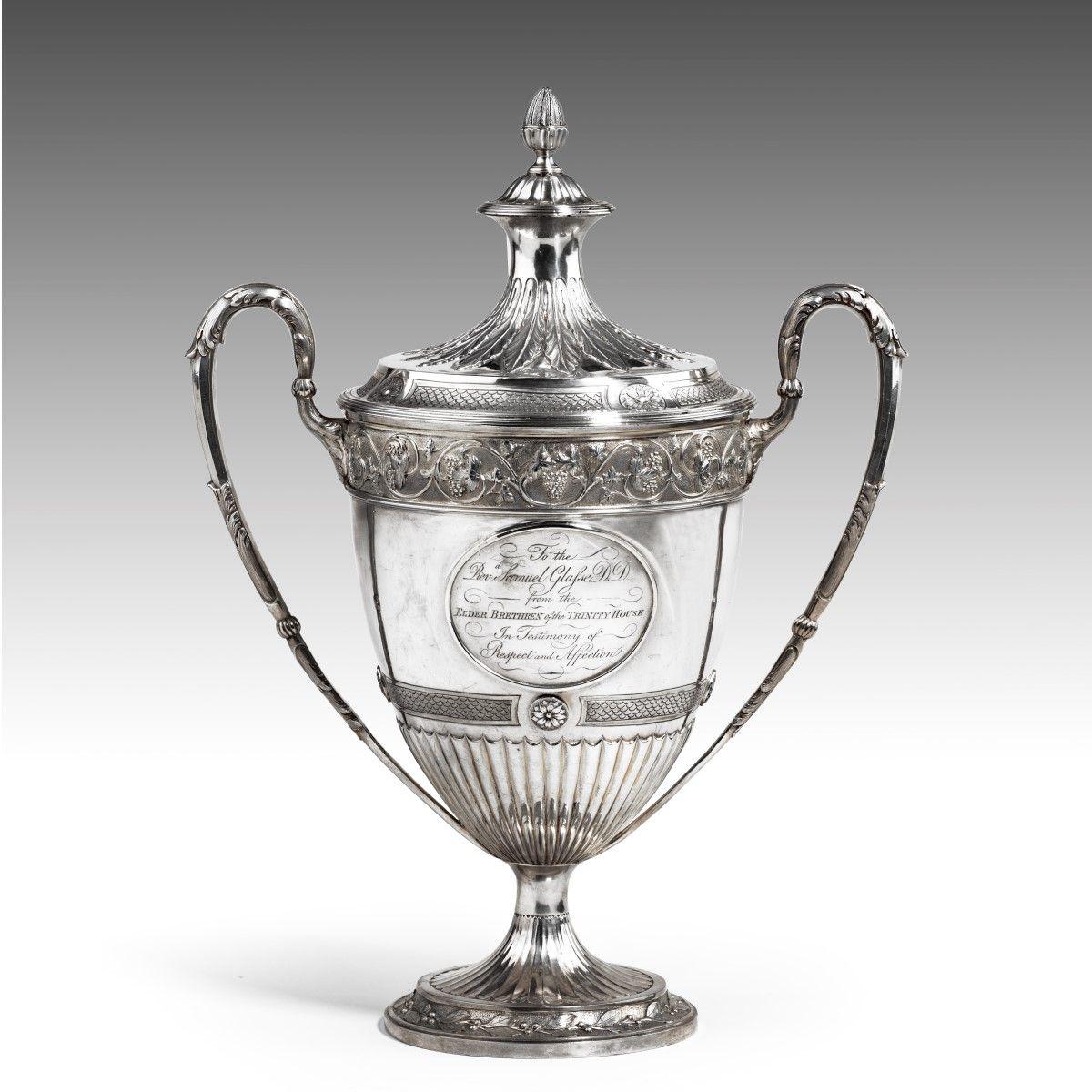 Trinity House silver presentation cup and cover, 1795. This cup is modelled in the classical style with a fluted foot chased with a band of laurel leaves supporting the fluted lower body decorated with a band of fish scale decoration intersected by