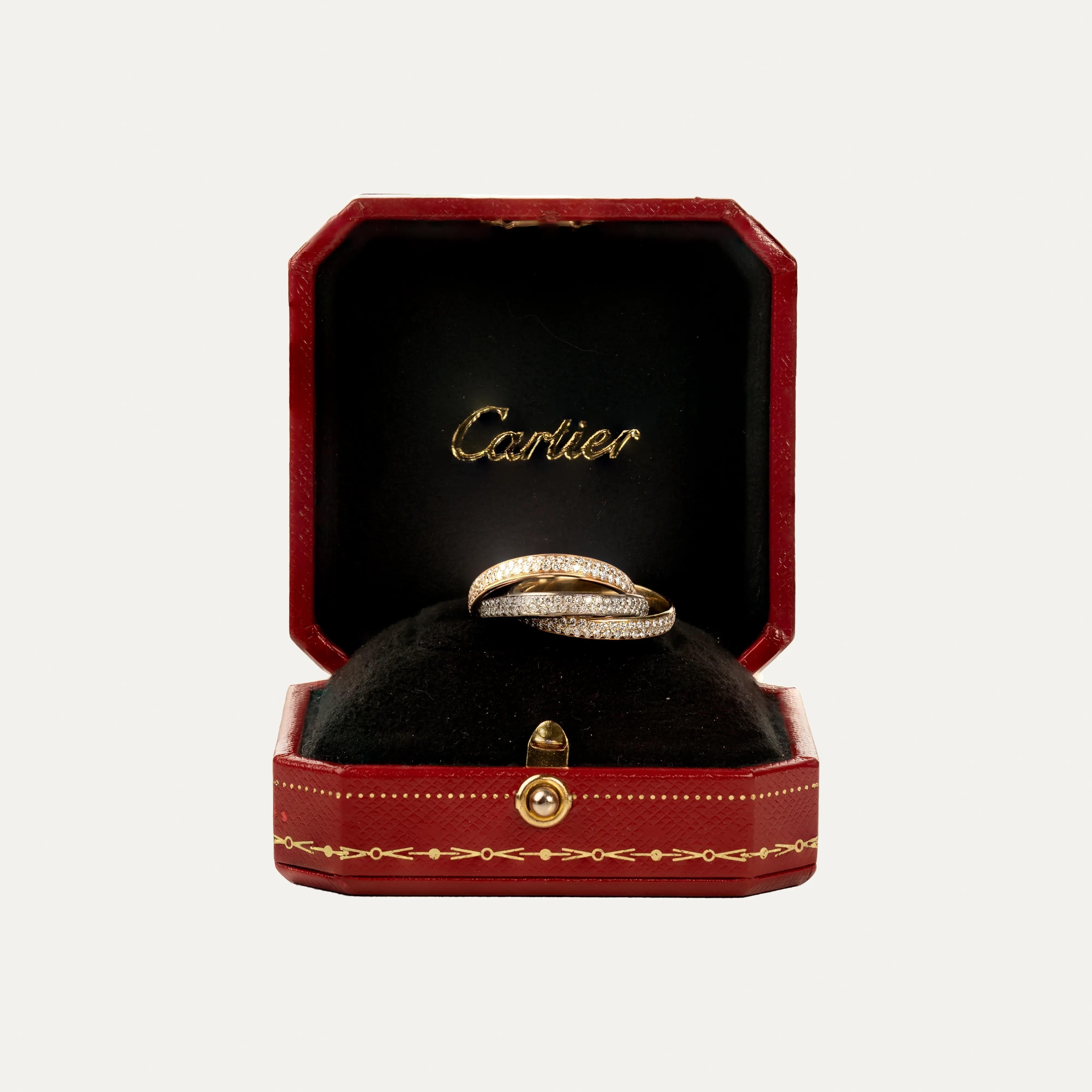 Cartier Trinity Ring, White Gold 750/1000, Rose Gold 750/1000, Yellow Gold 750/1000 with Diamonds

Three interlocking bands pavé set with brilliant-cut diamonds. Small model. Supplied with Cartier certificate of authenticity, original box and