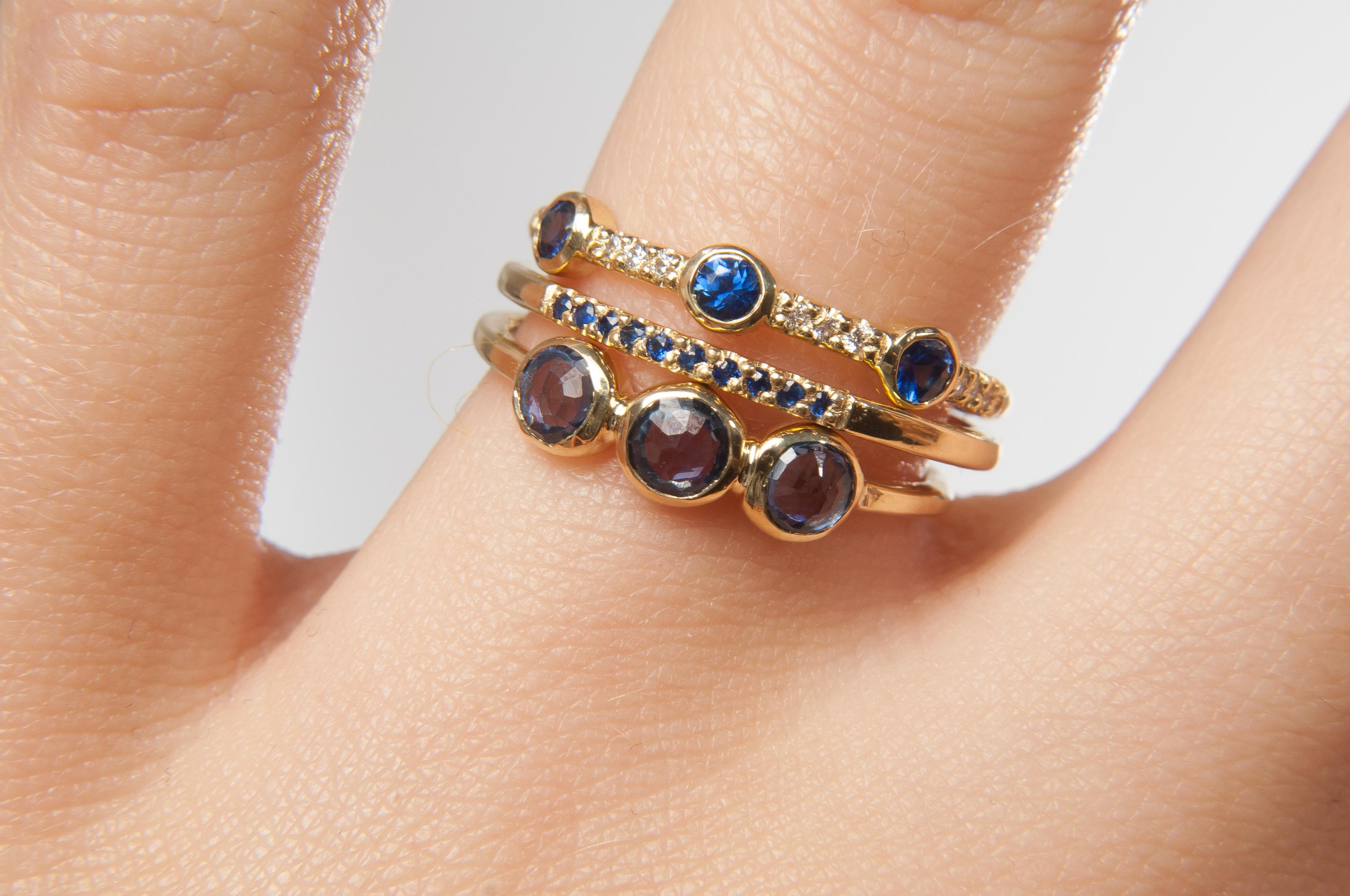 Update your look with this modern take on a classic three stone ring.

18K yellow gold band set with three bezel set 0.12” blue sapphires.

Size 6
